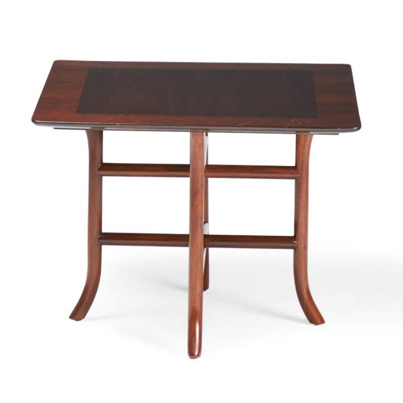 American Mid-Century (1950s) walnut occasional / side table with a square top supported by a crossed trestle base with curved sabre feet. (T.H. ROBSJOHN-GIBBINGS FOR WIDDICOMB FURNITURE)(Similar pieces with different finishes: DUF0147A-D)
