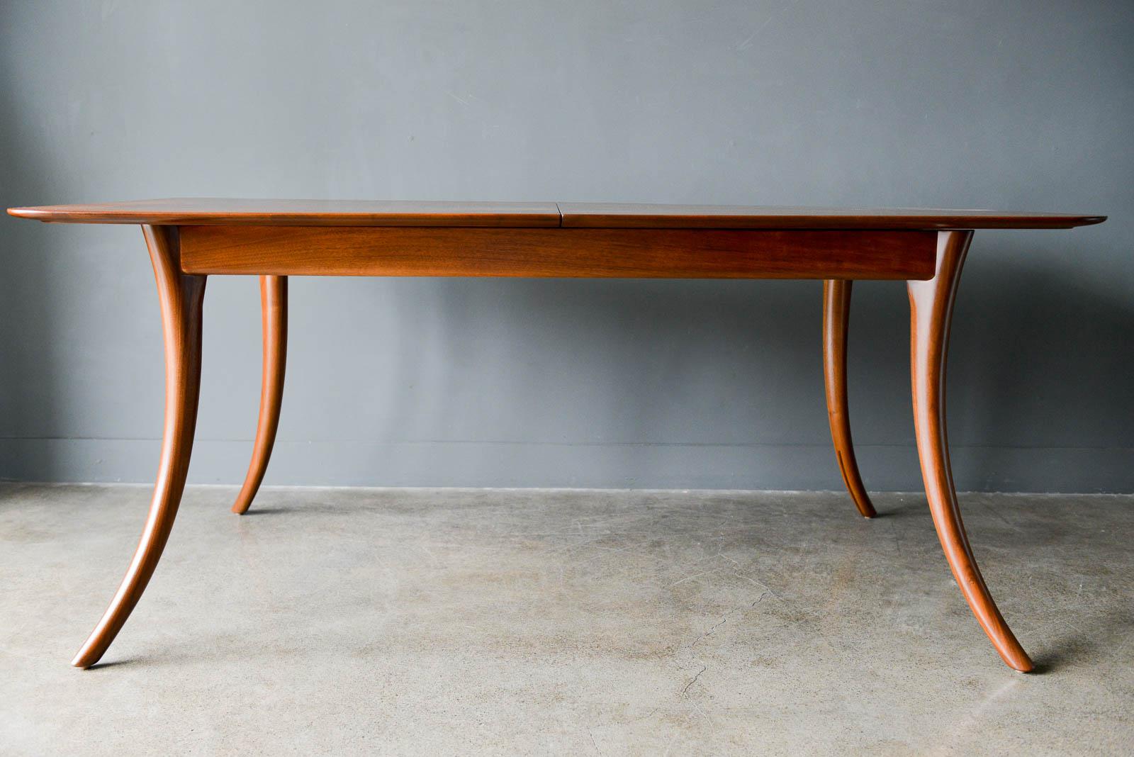 T.H. Robsjohn-Gibbings Klismos dining table, model 4301, ca. 1955. Beautiful and desirable sabre leg design professionally restored in showroom condition. Includes two 18