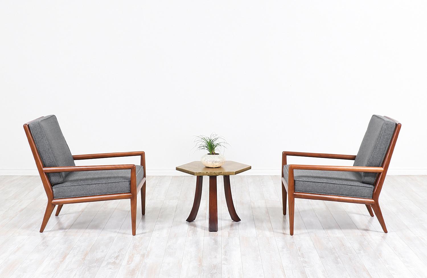 Elegant modern lounge chairs designed by T.H. Robsjohn-Gibbings for Widdicomb in the United States, circa 1950s. These midcentury ergonomic lounge chairs feature a solid walnut wood frame with angled legs and a slatted back, guaranteeing a handsome