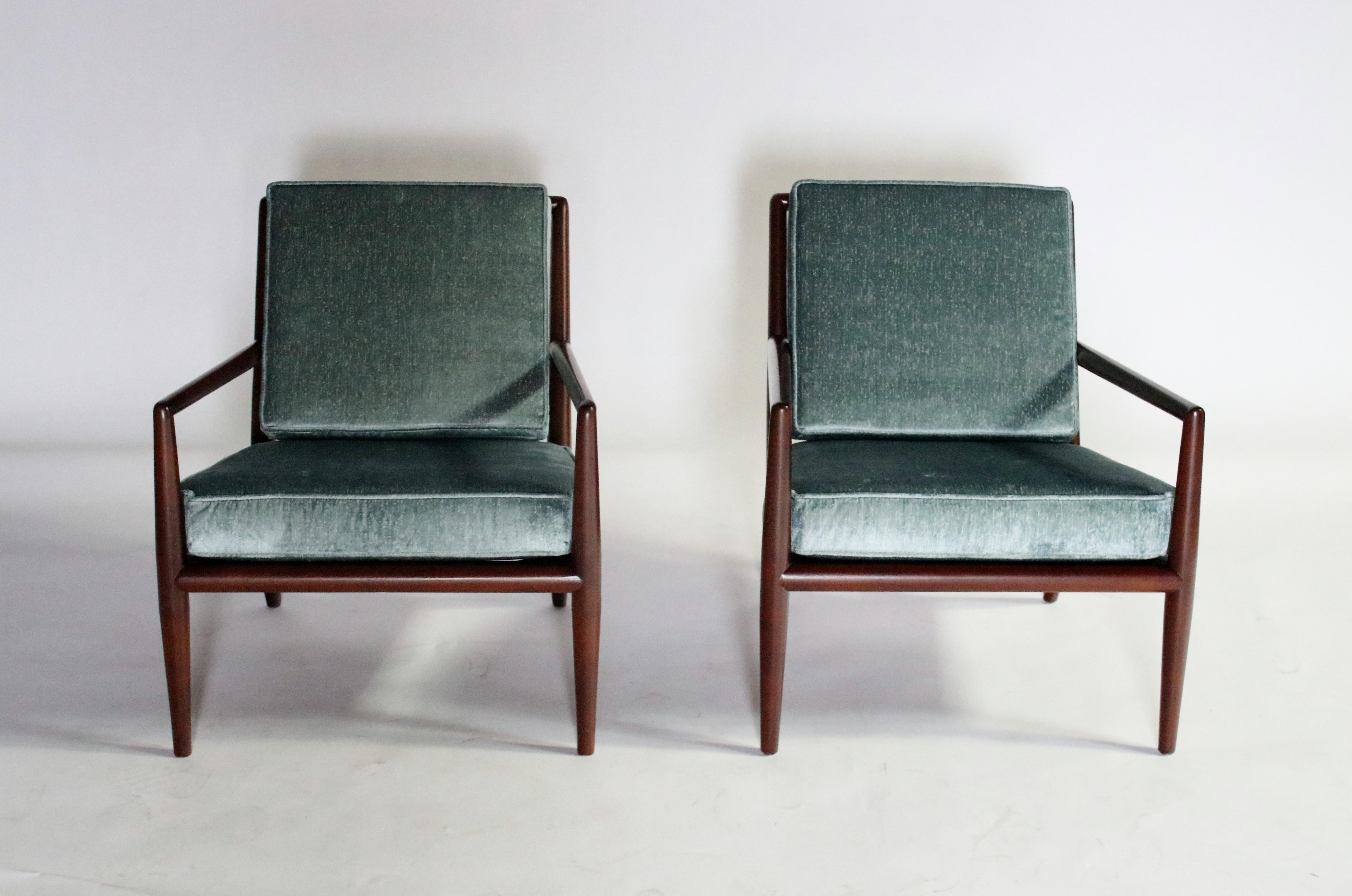 Elegantly updated 1950s walnut frame lounge chairs by T.H. Robsjohn Gibbings restored and reupholstered in a steel blue velvet high-end fabric.