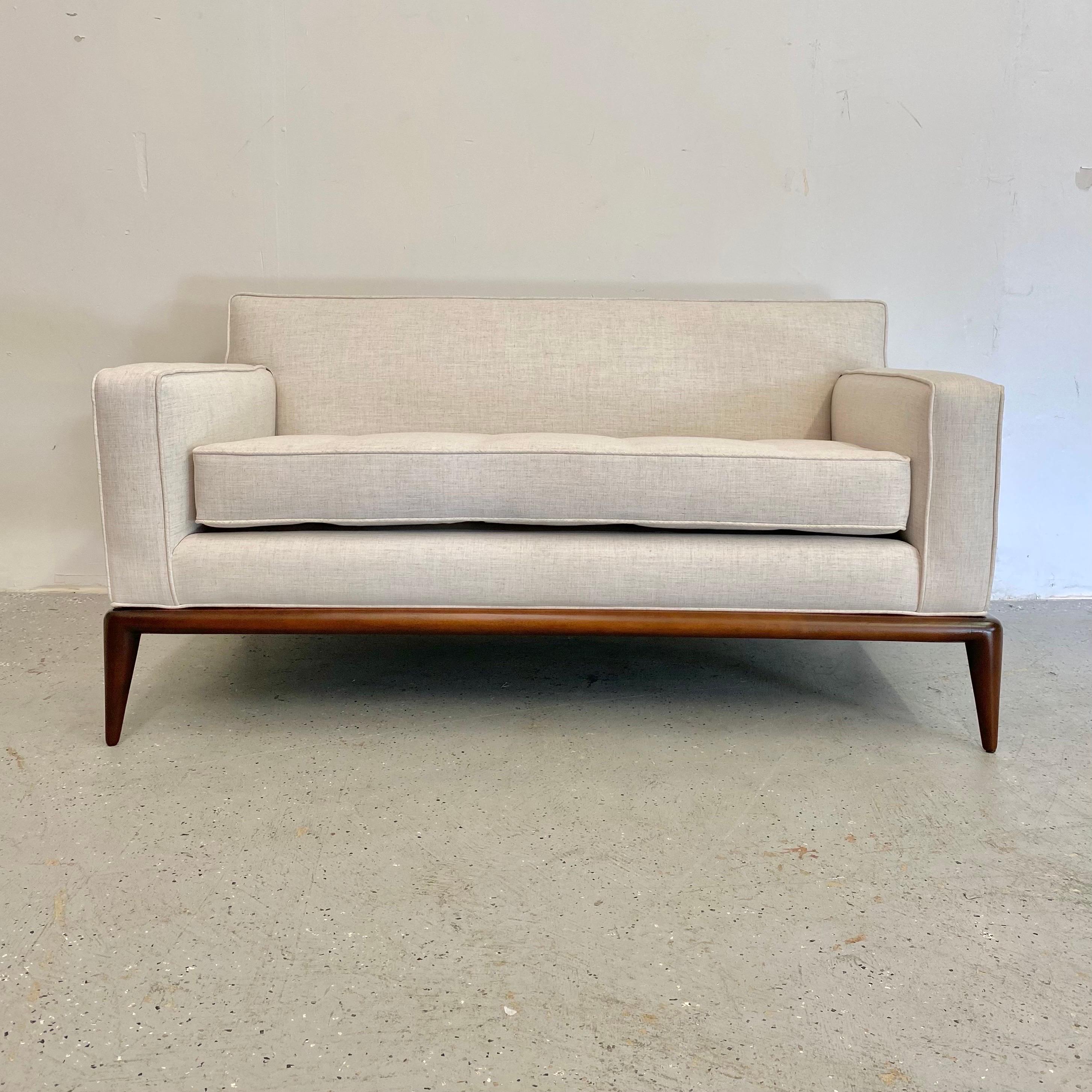 An elegant modern piece, newly upholstered with refinished walnut toned base.
A classic from Robbsjohn-Gibbings with light khaki linen upholstery.