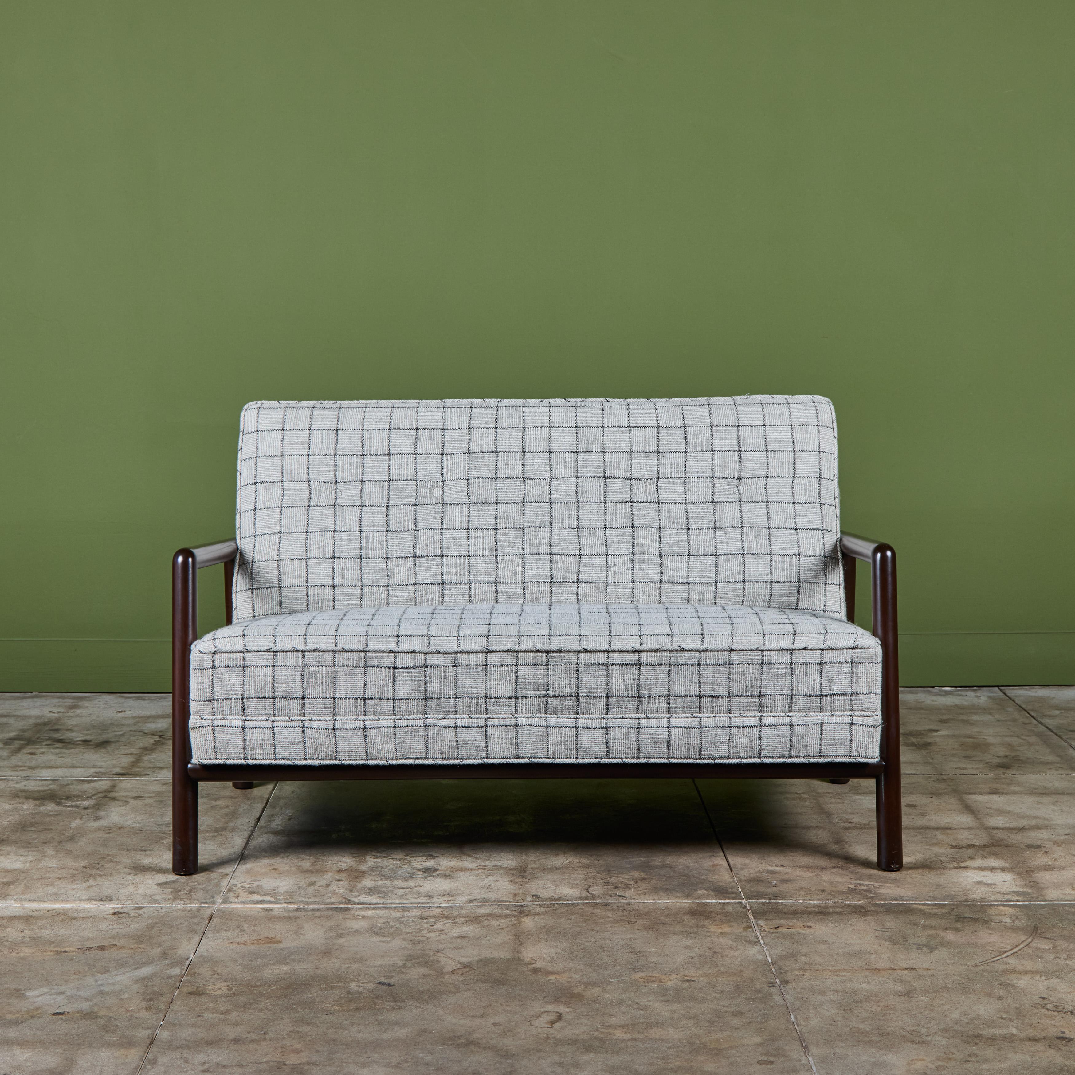 Loveseat by T.H Robsjohn Gibbings, for Widdicomb c.1950s USA. This sofa features rounded stained beech wood frame with armrests. The cushions have been newly reupholstered in a gray window pane wool blend fabric with a tufted back rest.

Dimensions: