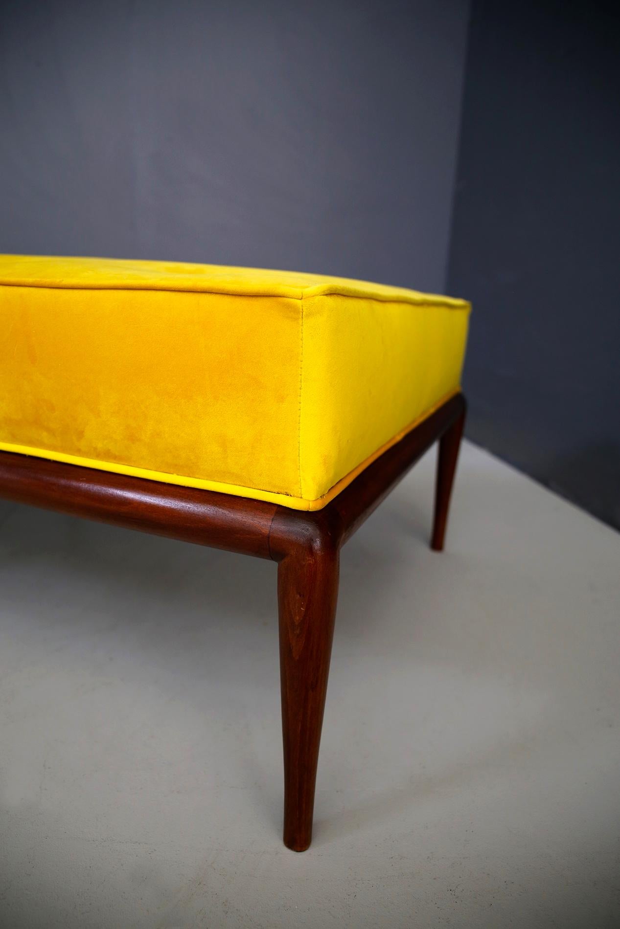 Daybed designed by T.H. Robsjohn-Gibbings, circa 1950. The bench has been restored and covered in yellow velvet with button insertion. The structure of the bench is in walnut. The bench is ideal for complete relaxation in the lounge area or to