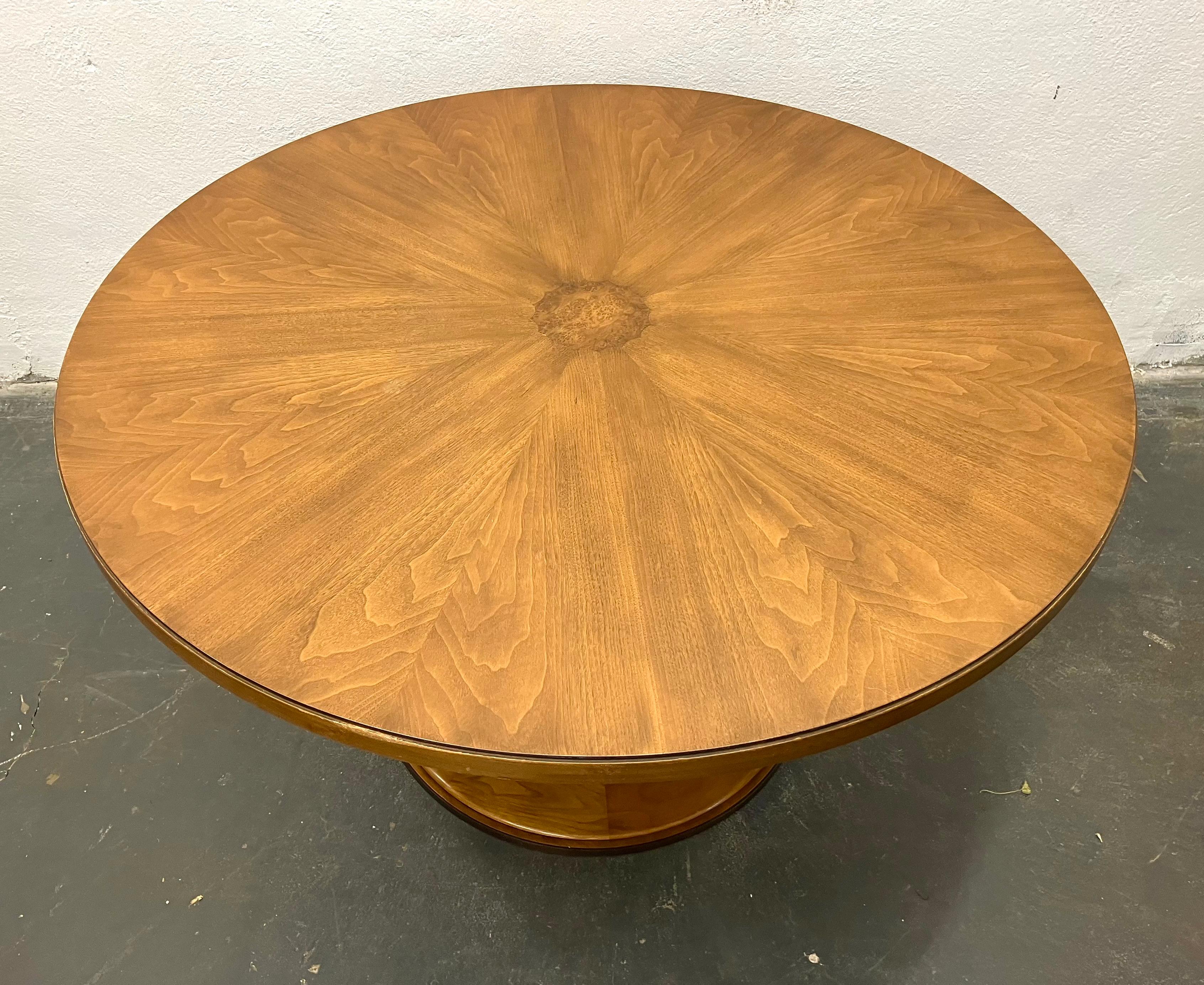 Elegant neoclassically styled centre or lamp table from the rare one year collaboration with Baker furniture in 1961. The fluted walnut center pedestal sits on a brass rimmed base. The top surface is veneered in a star pattern with burl center