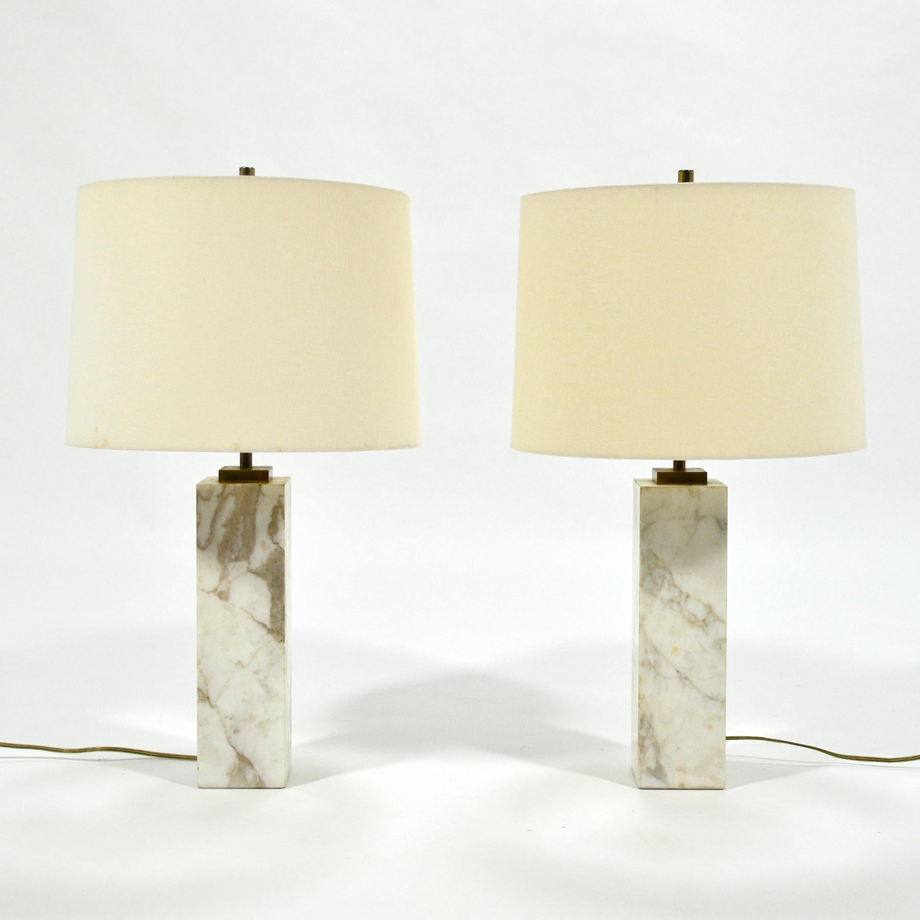 A sublime design by Robsjohn-Gibbings, this pair of model no. 180 table lamps take a minimalist design and luxurious materials to their logical conclusion. Rectangular bases of beautifully figured 