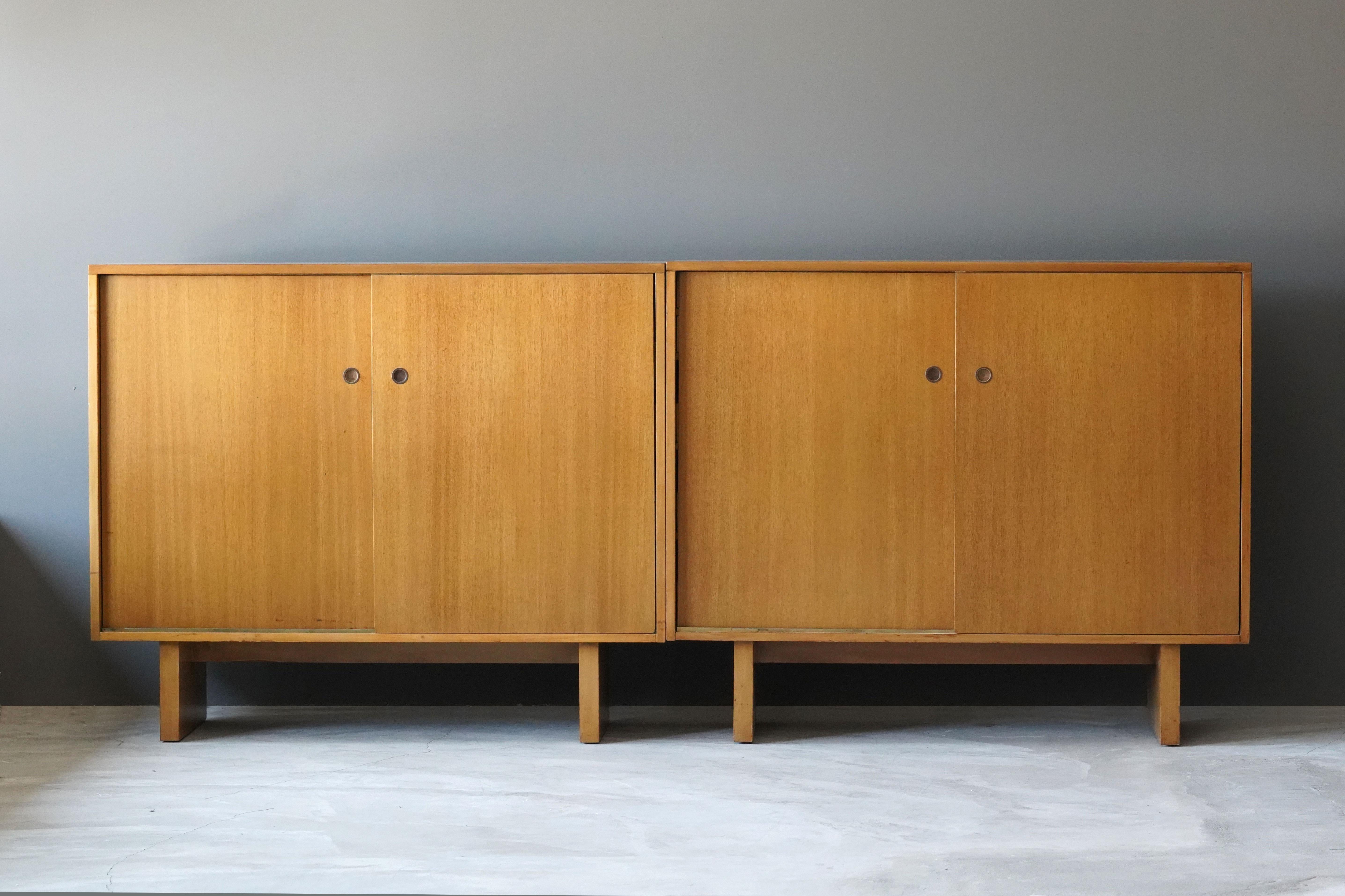 A pair of rare cabinets / sideboards / buffets / cupboards or credenzas. Designed by British / American designer T.H. Robsjohn-Gibbings. Produced by Widdicomb Furniture Company, Grand Rapids, Michigan. Labeled. Features intricate and highly