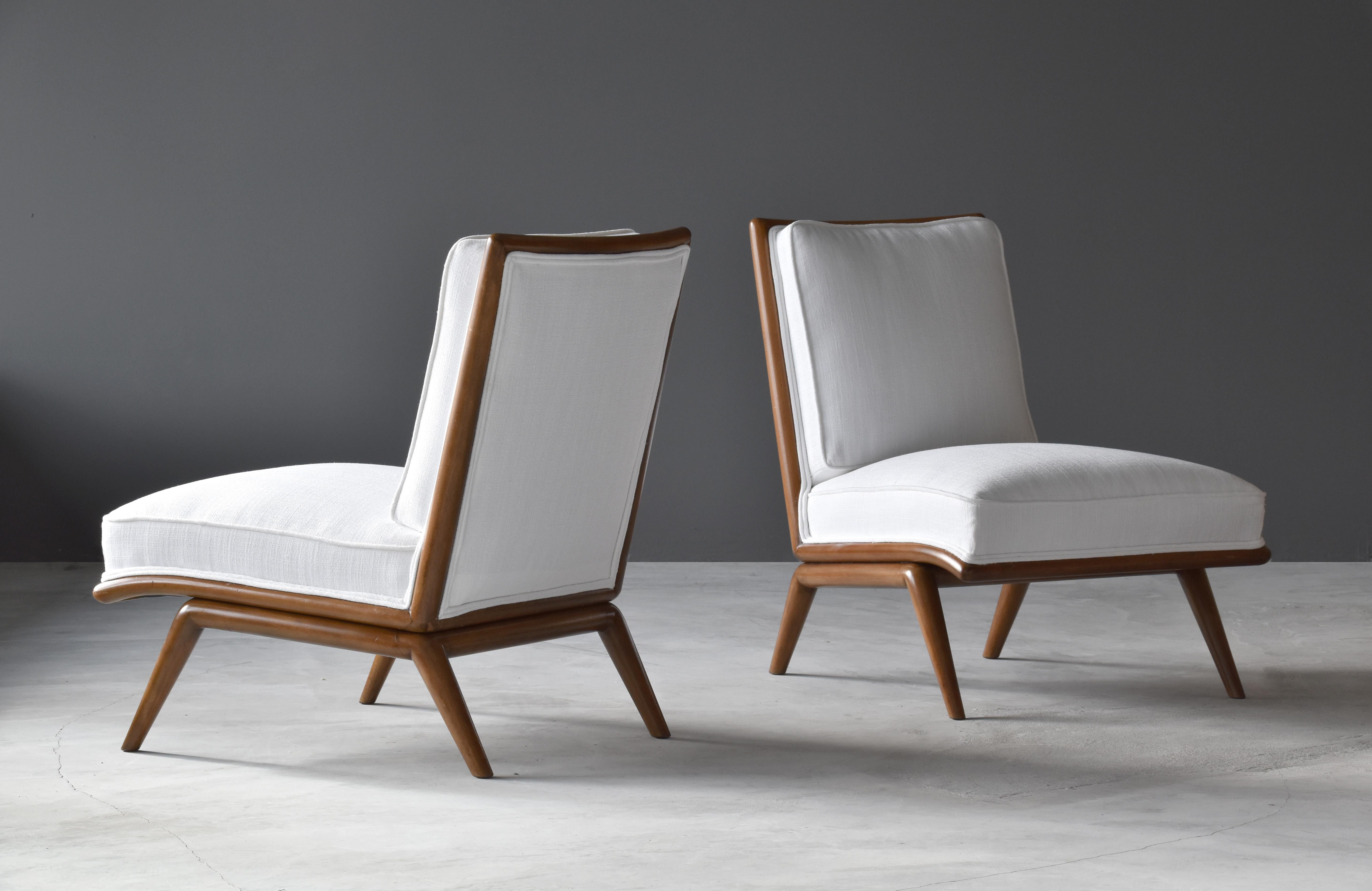 A pair of rare slipper chairs designed by T.H. Robsjohn-Gibbings. Produced by Widdicomb Furniture Company in Grand Rapids, Michigan, circa 1950s.

A mostly linear form gives this Robsjohn-Gibbings design an unusually Modern expression. The walnut
