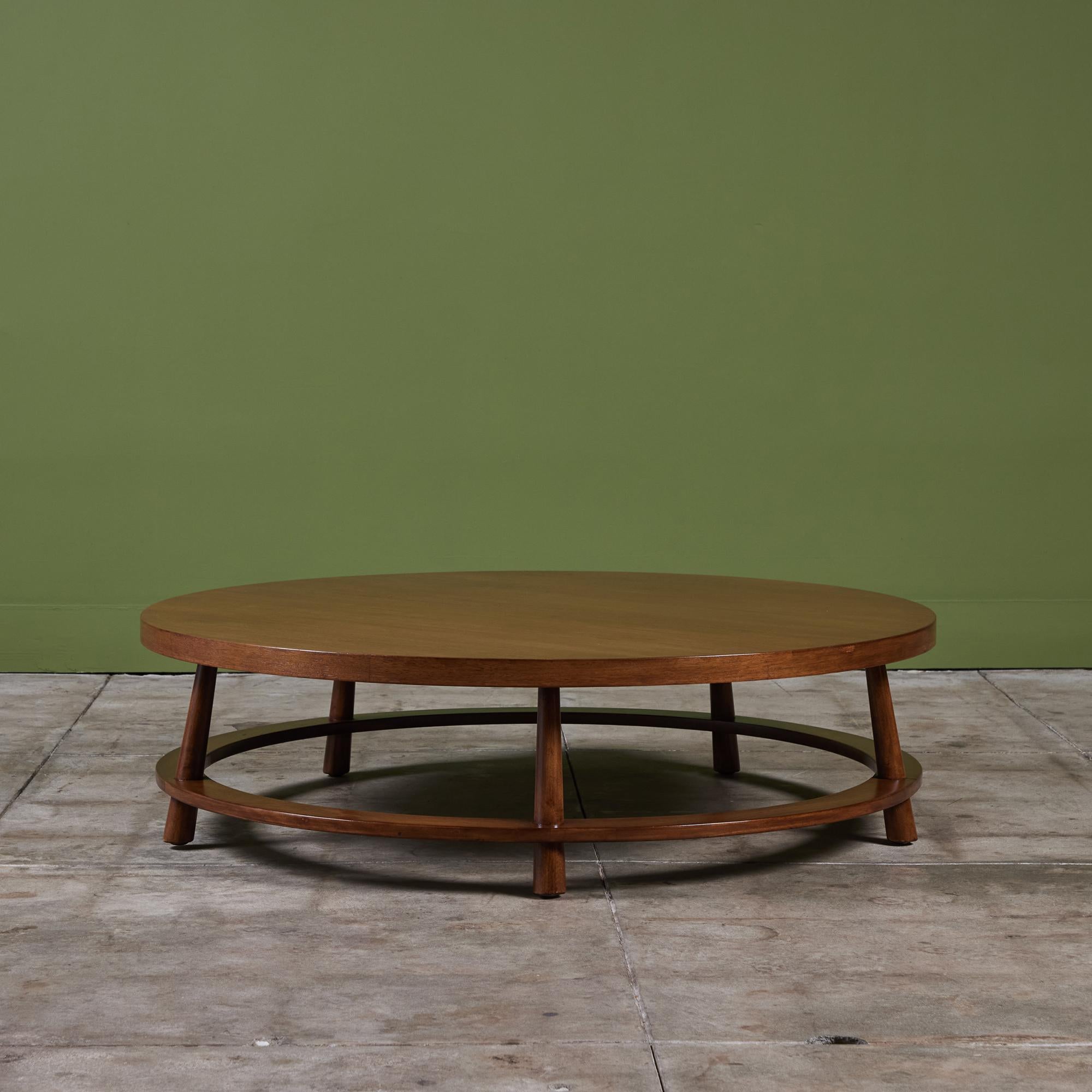 Coffee table by T.H Robsjohn Gibbings, manufactured by Widdicomb c.1950s, USA. This beautiful walnut table features a round table top with five slightly splayed legs and a stretcher that rounds the perimeter of the table.

Dimensions
48
