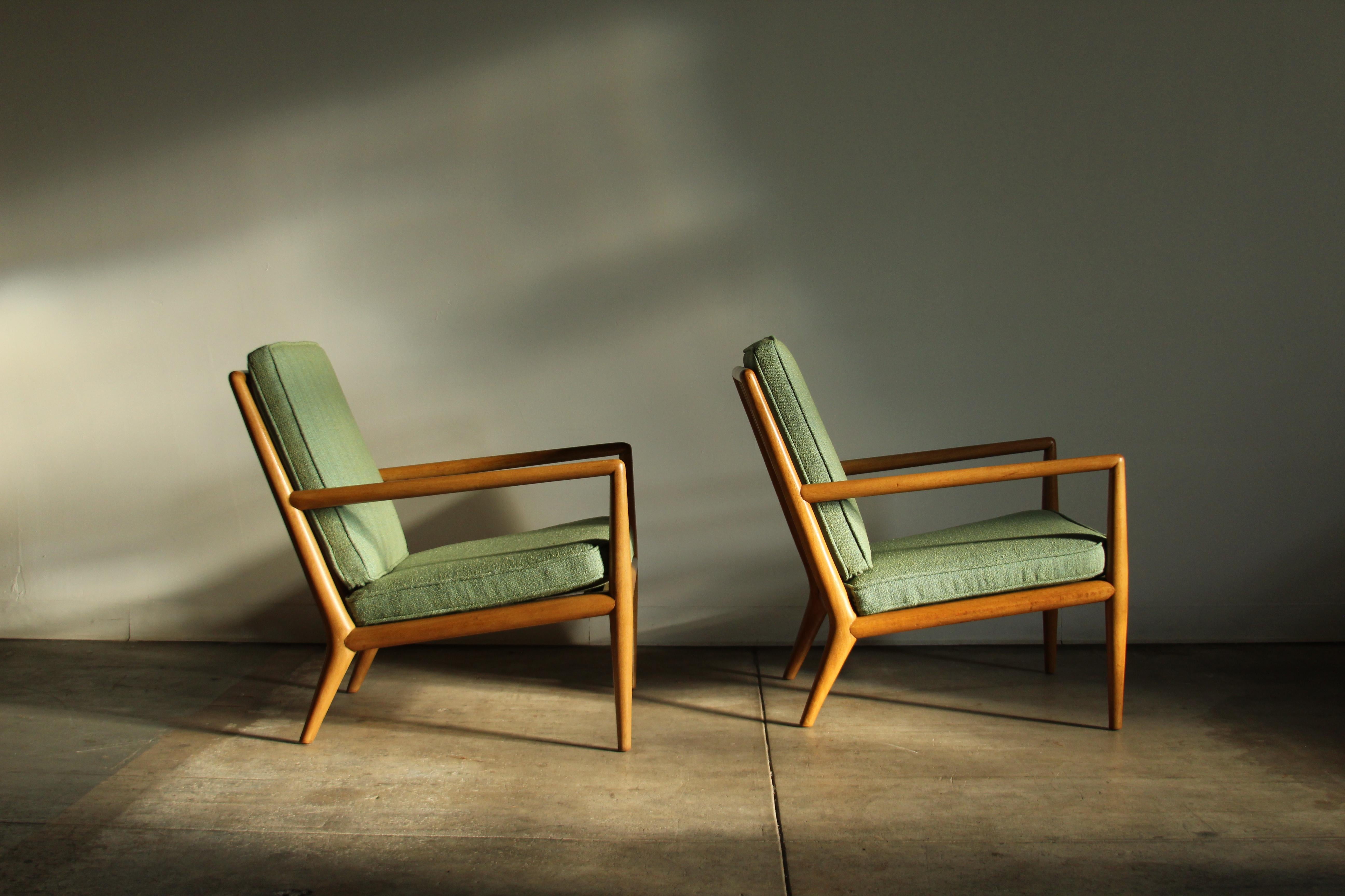 A lovely pair of lounge chairs by T.H. Robsjohn-Gibbings for Widdicomb circa 1950s. These stunning beauties boast a totally sculptural frame with angular arms and thick spindled backs. Notice how the sculpted arms smoothly cascade down into the