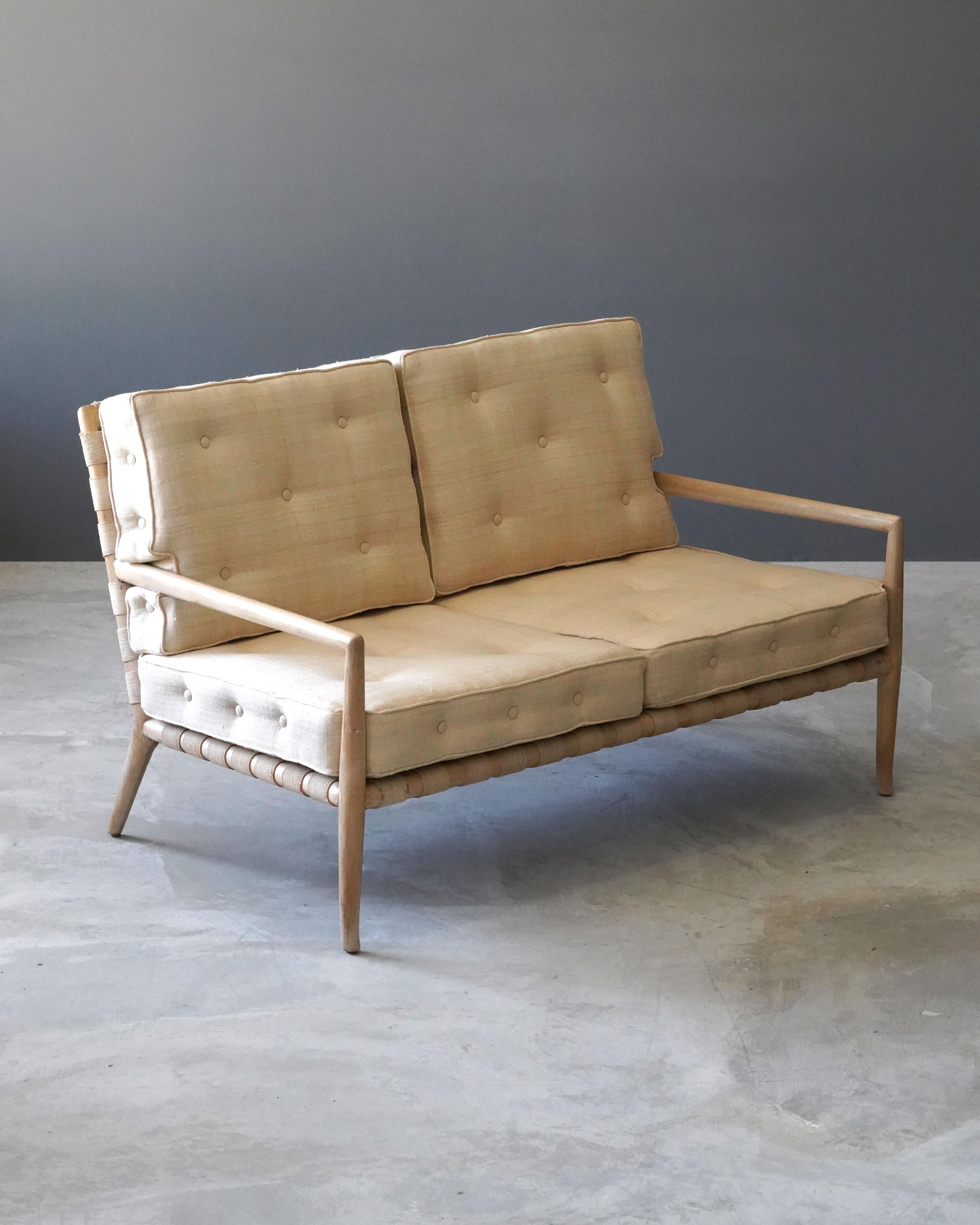 A lounge settee or 2-seat sofa designed by T.H. Robsjohn-Gibbings. Produced by Widdicomb Furniture Company in Grand Rapids, Michigan, circa 1950s. Executed in walnut, original webbing, seat cushions with brand new high-end fabric upholstery.