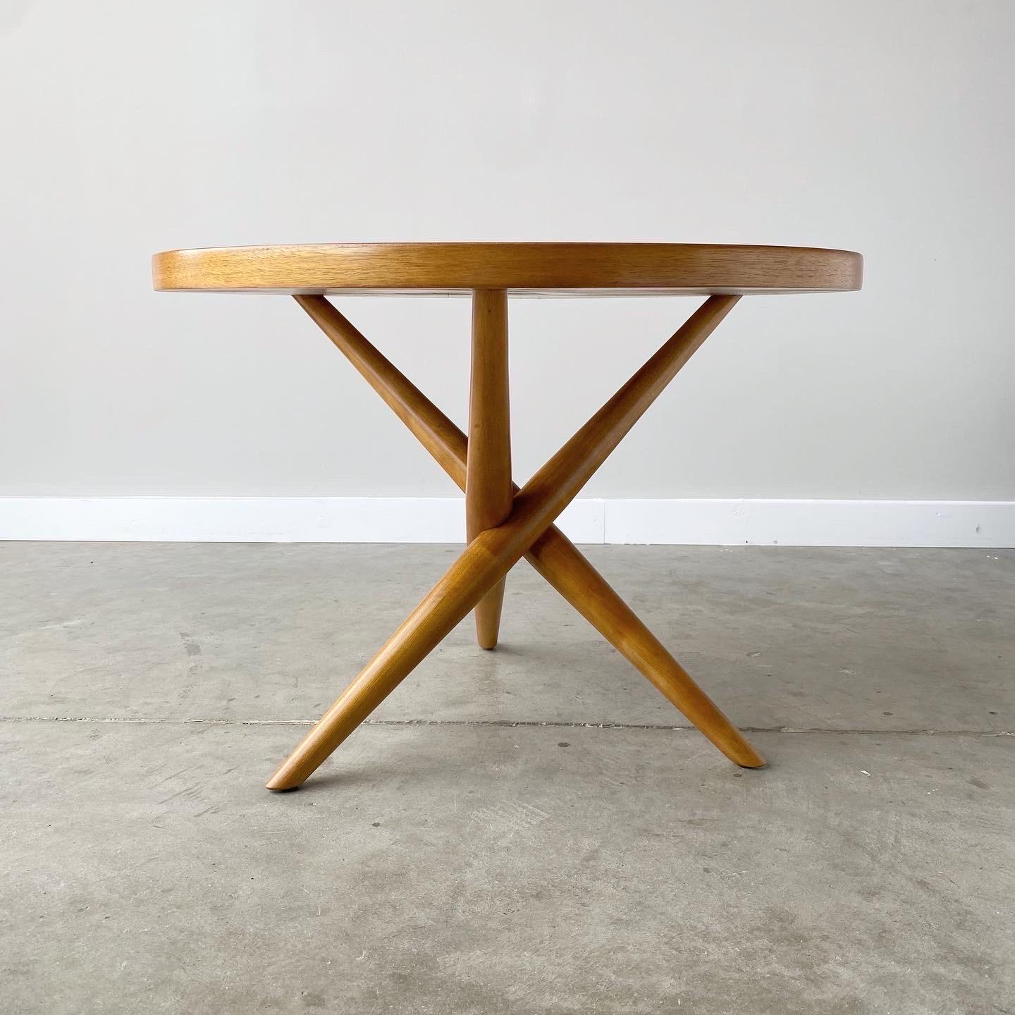 An iconic tripod table designed by T.H. Robsjohn-Gibbings for Widdicomb, 1952.

This table has been refinished professionally and features a bleached walnut top with maple legs.  