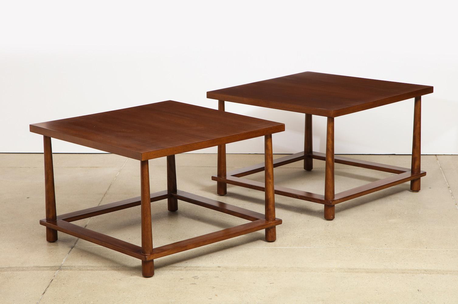 TH Robsjohn-Gibbings pair of large scale side tables. Figured walnut tables of square form featuring reverse-tapered legs and low stretchers. Manufactured by Widdicomb Furniture Company, these tables were only in production for a short period of