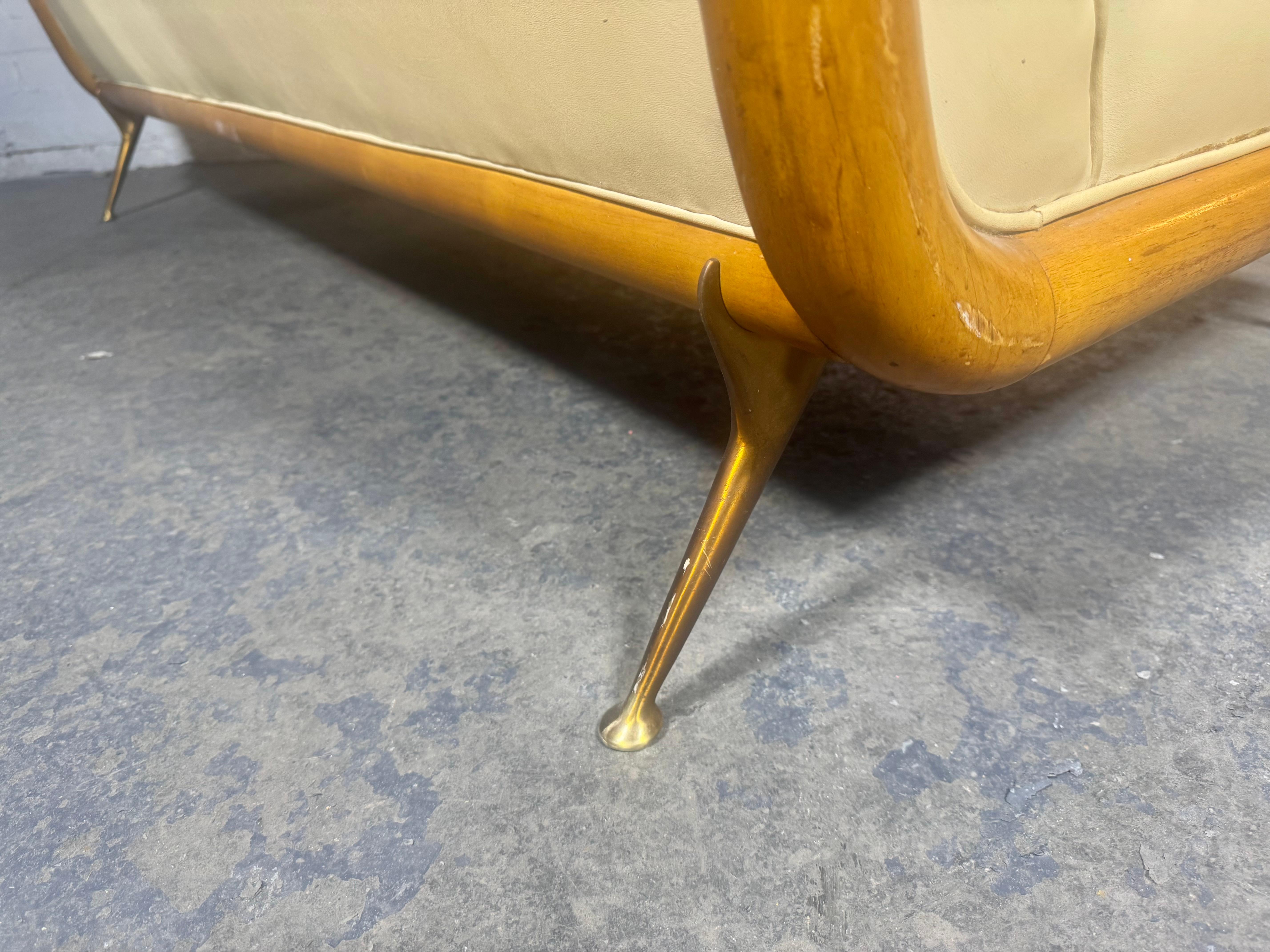 T.H. Robsjohn-Gibbings Sofa, for Widdicomb Model 1727 c.1950 / walnut & brass frame.. Retains original off white / cream  naugahyde upholstery . usable but  dis-colored, Retains original finish , patina, some scratches ( see photo). Amazing solid