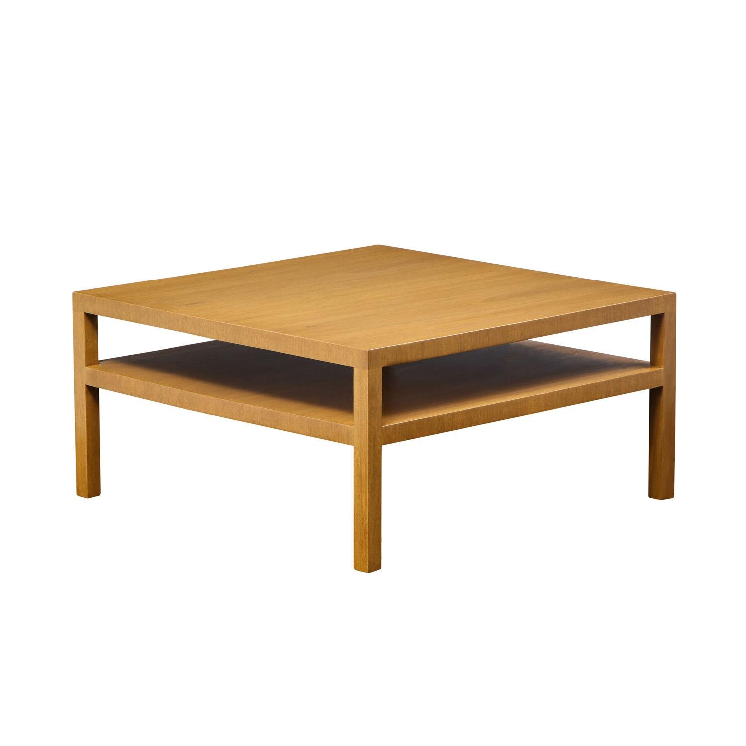 Square 2-tier coffee table in walnut by T.H. Robsjohn-Gibbings for Widdicomb, American 1940's (label on bottom). Newly refinished by Lobel Modern. This clean-line coffee table is very elegant and would add beauty to any interior.