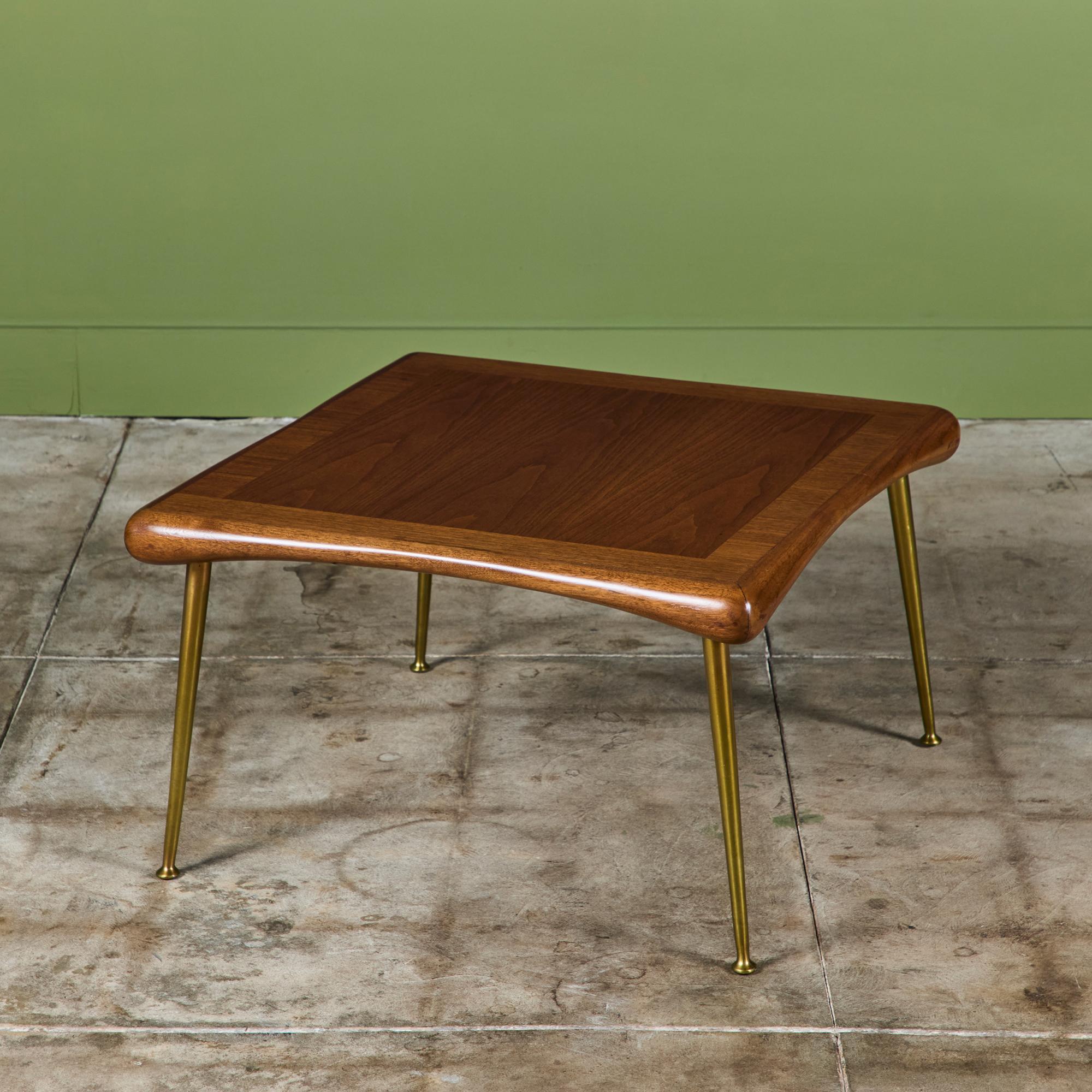Square coffee table by T.H Robsjohn Gibbings, manufactured by Widdicomb c.1950s, USA. The walnut table features four brass peg legs, with a rounded edge table top that slightly curves inwards on each side.

Dimensions
27.5