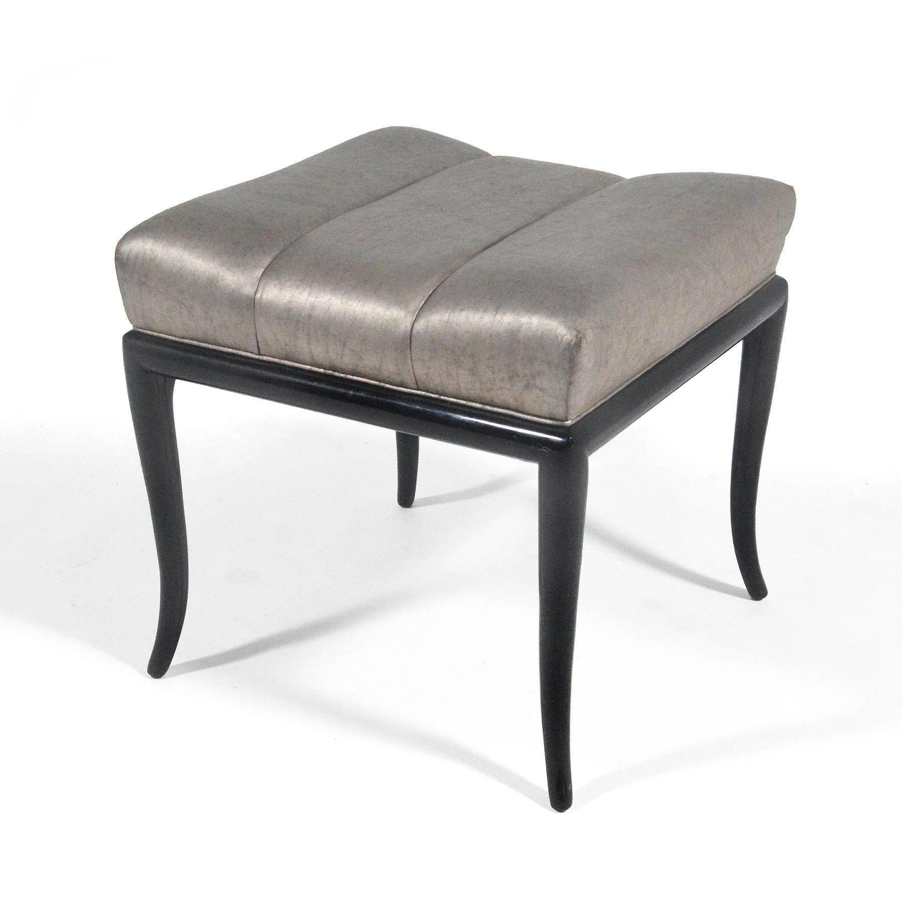 Typical of Robsjohn-Gibbings' refined aesthetic, this stool is elegant and sexy, with graceful lines. The base is finished in black lacquer and topped with a seat upholstered in a champaign colored silk.