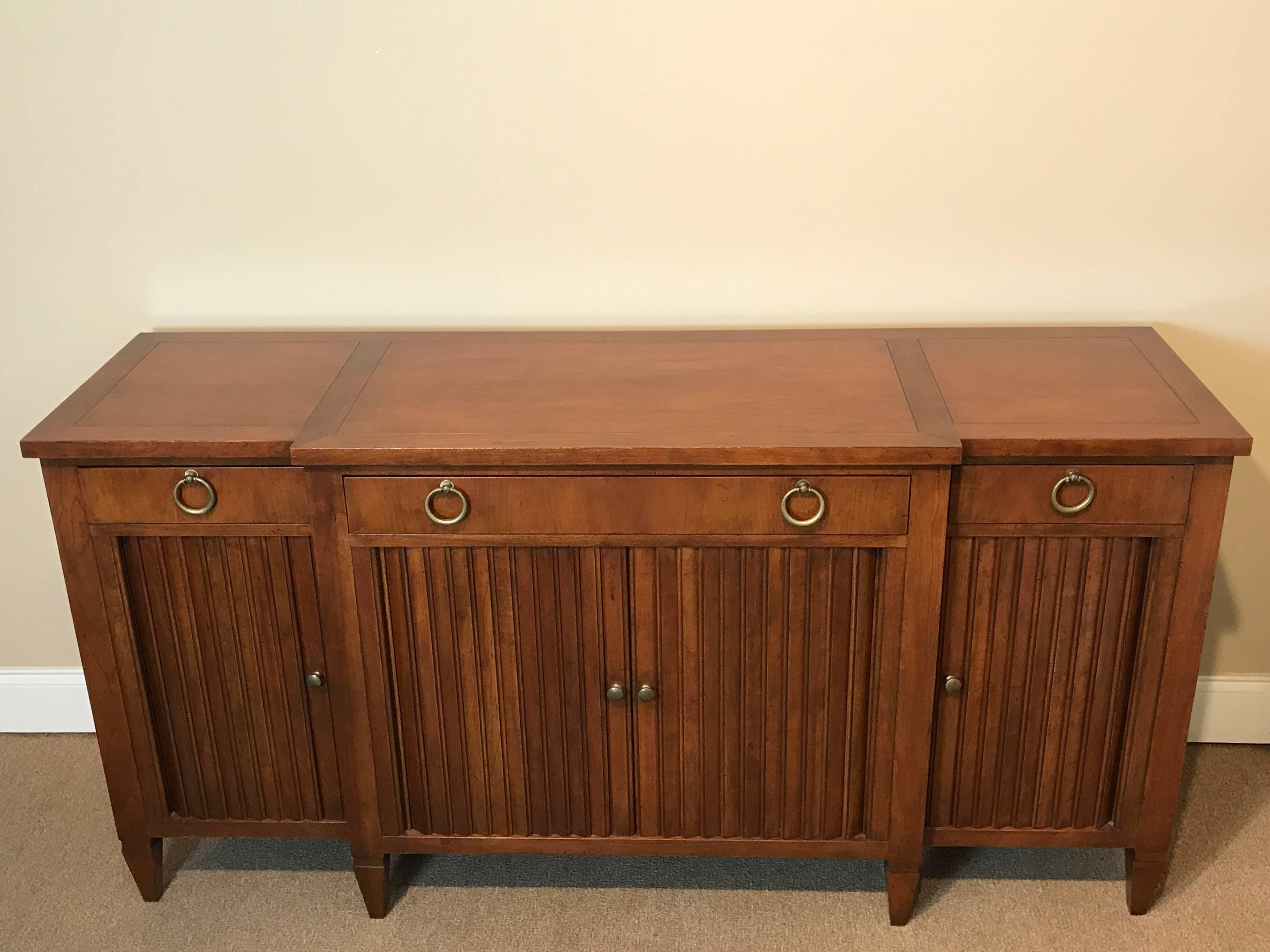 T.H. Robsjohn-Gibbings style sideboard by Baker, fitted with three drawers with ring handles, and three lower tambour doors
The drawers measure 12