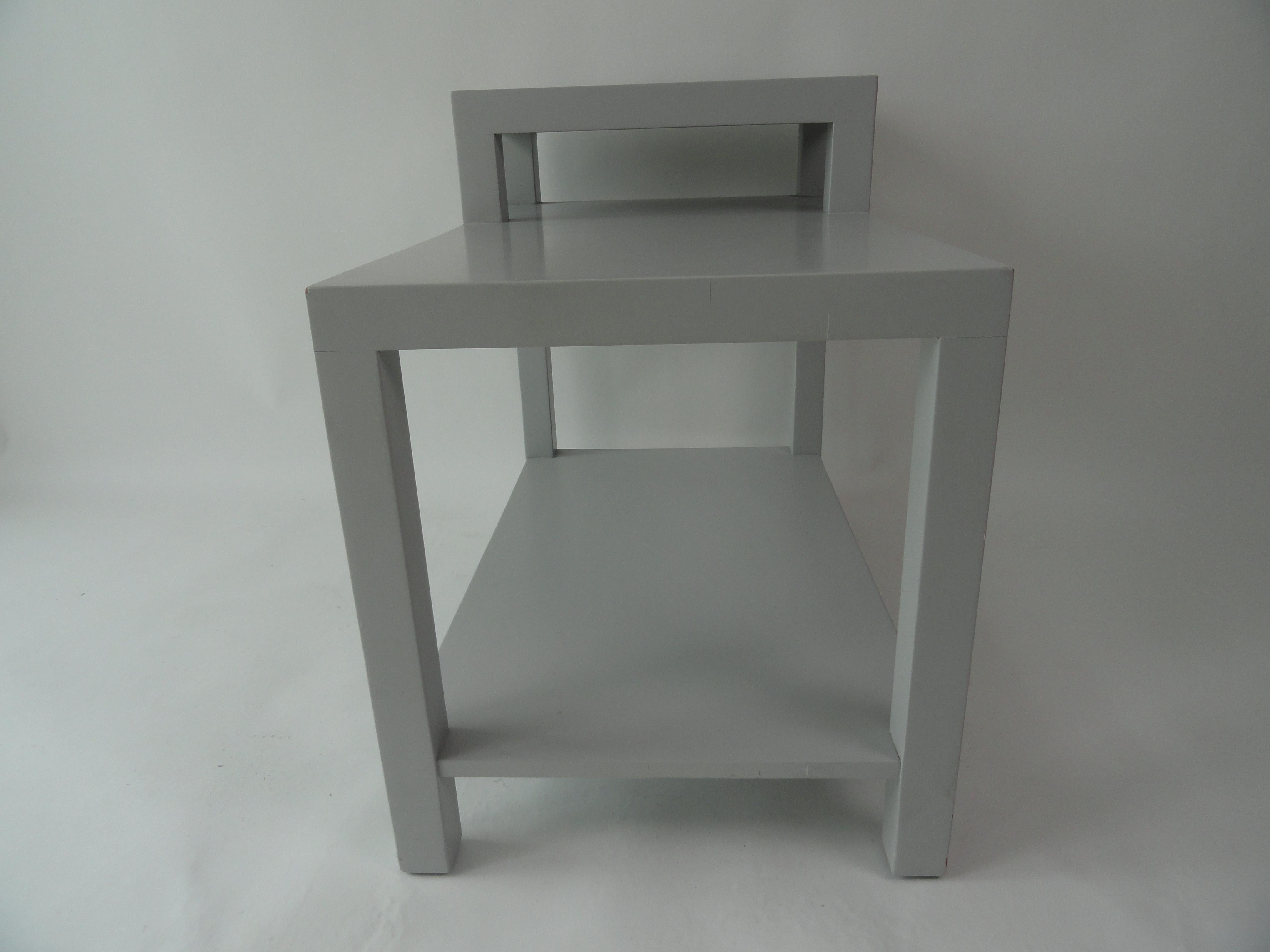T.H. Robsjohn-Gibbings step table finished in light gray for John Stuart Furniture. Labeled.