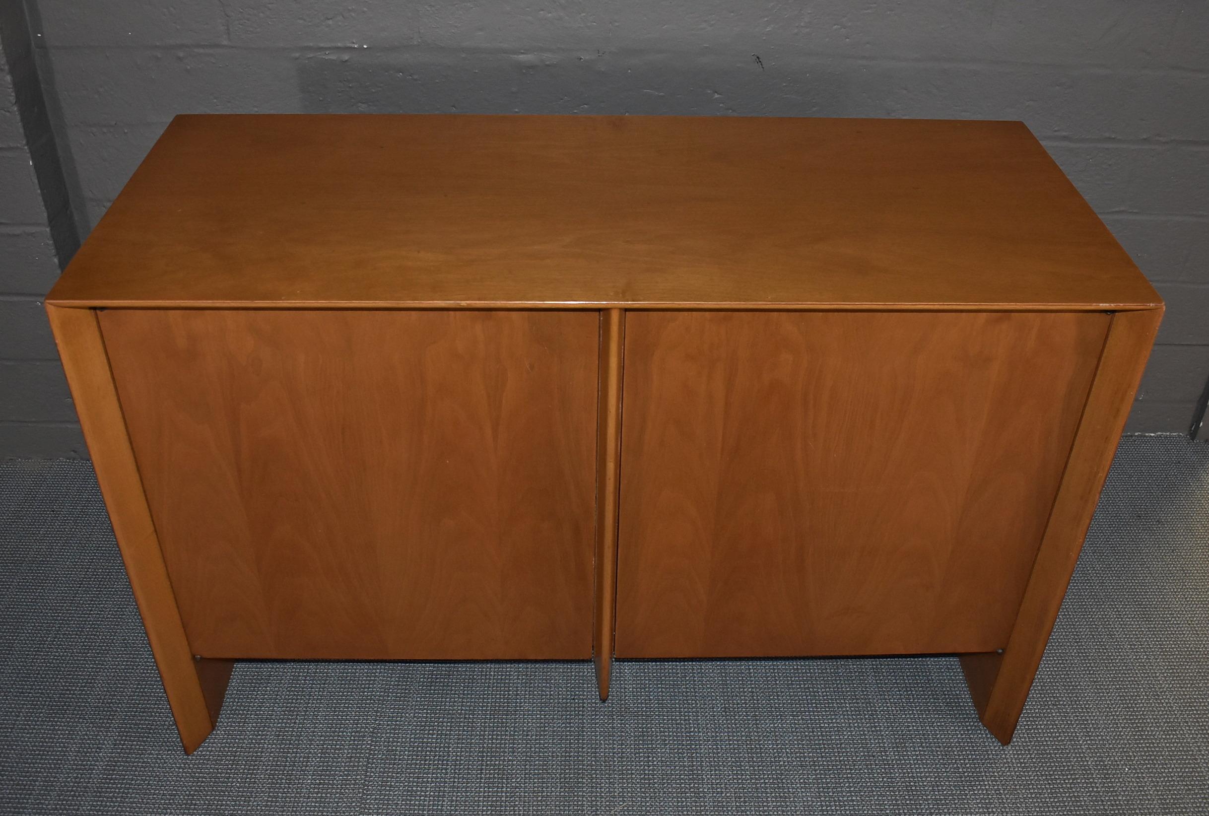 Two-door Mid-Century Modern credenza by T. H. Robsjohn-Gibbings for Widdicomb. Made from walnut and has three interior drawers. Adjustable interior shelves. Original finish. Some surface wear to the top. 48.5