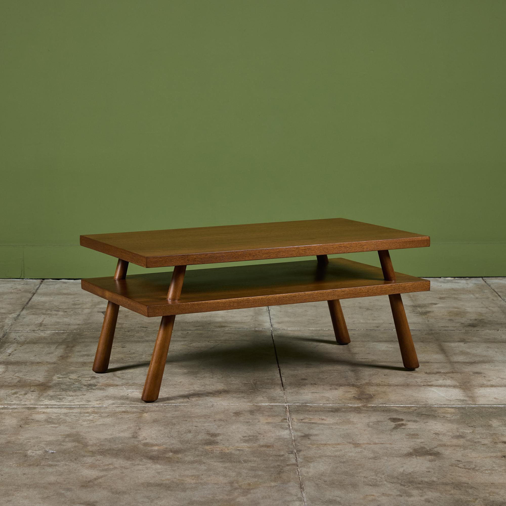 Coffee table by T.H Robsjohn Gibbings, manufactured by Widdicomb c.1950s, USA. This beautiful rectangular walnut table features two tiers with four splayed legs. Perfect as a coffee table, display table.

Dimensions
36