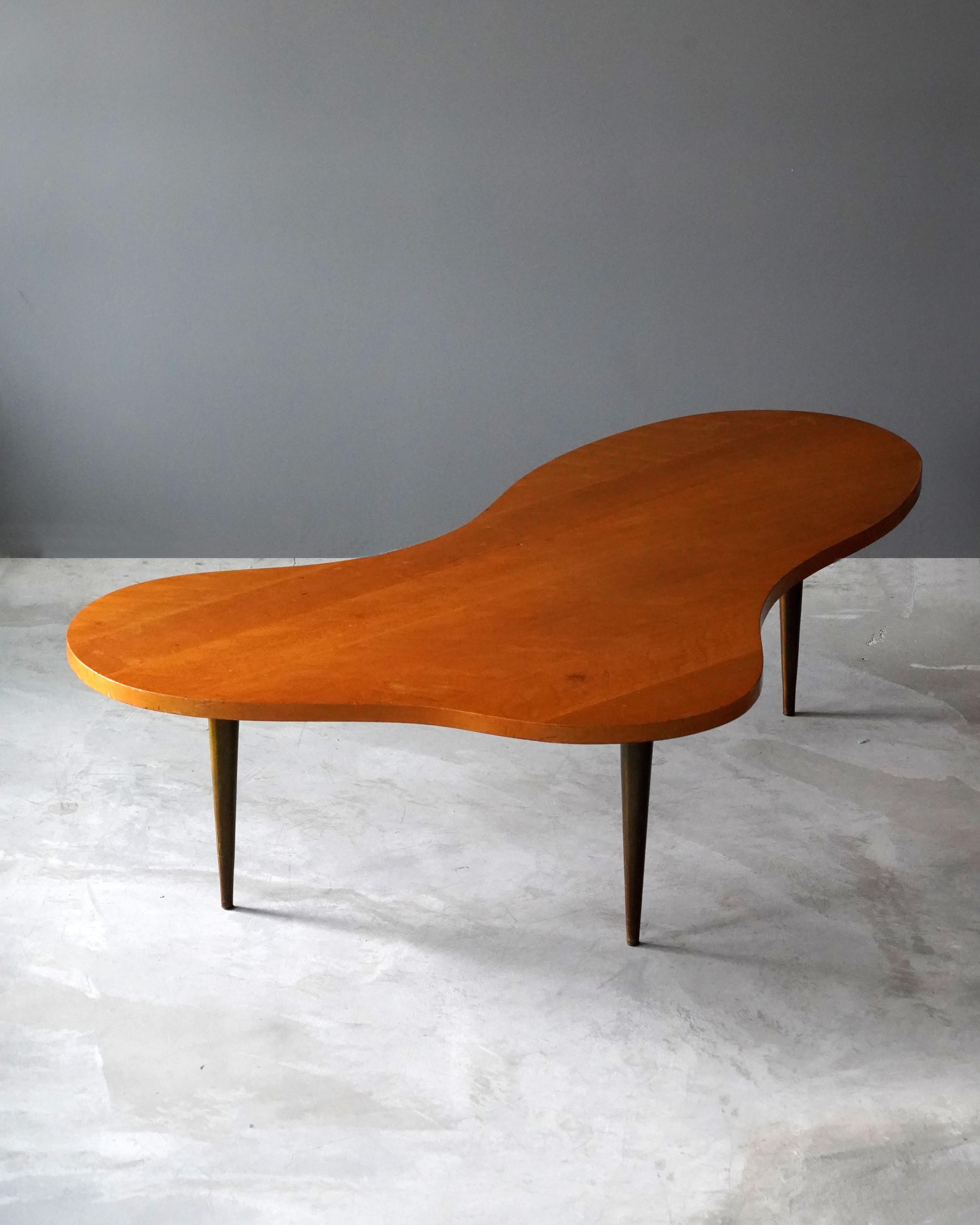 A rare large version organic coffee table / cocktail table. Designed by T.H. Robsjohn-Gibbings. Produced by Widdicomb Furniture Company in Grand Rapids, Michigan, circa 1950s. Executed in brass and walnut. 

Other American designers of the period