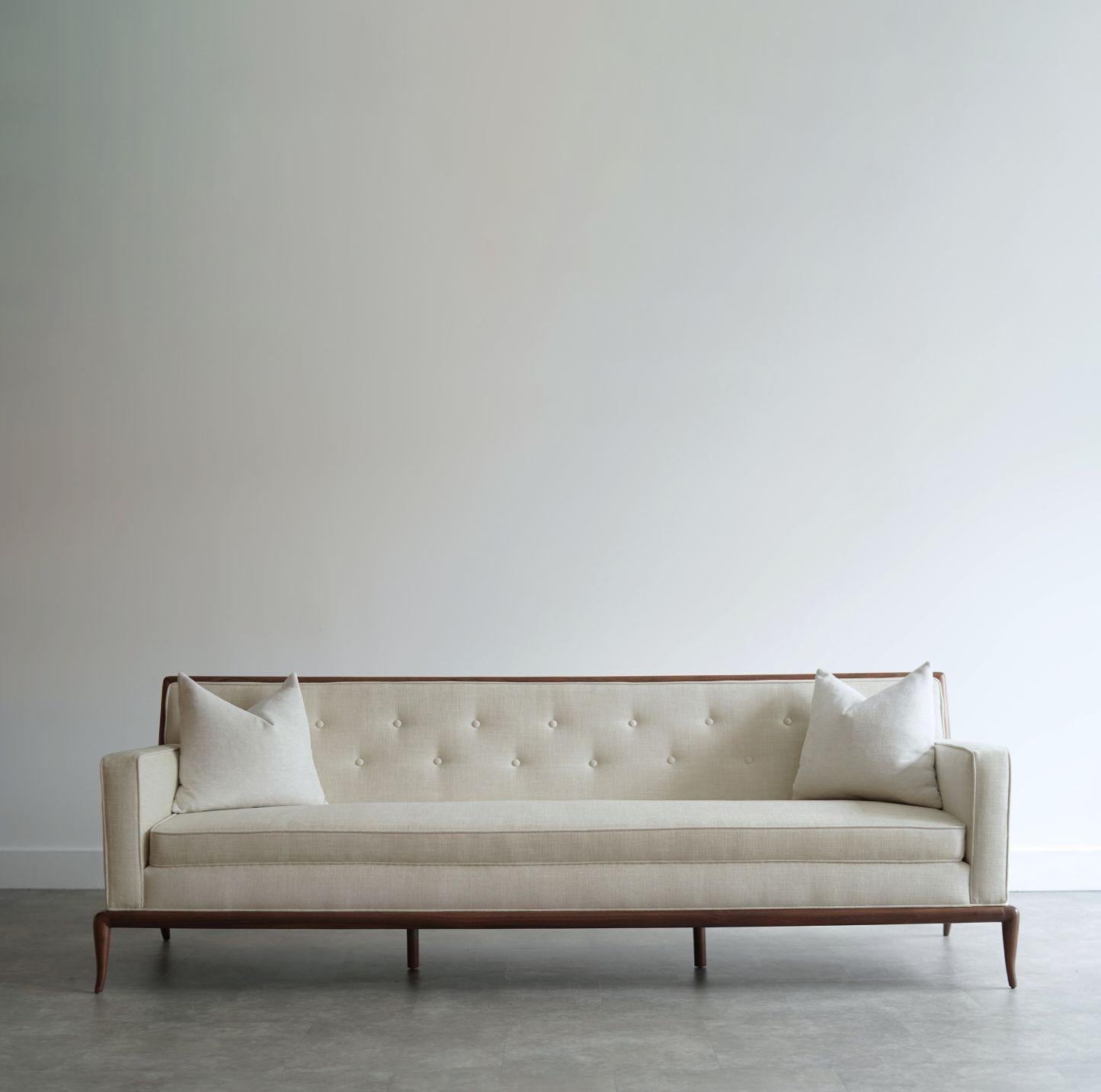 Sofa designed by T.H. Robsjohn-Gibbings for Widdicomb, circa 1950s. Expertly restored by Stamford Modern, it features a sculptural exposed walnut frame that highlights Gibbings' signature blend of elegance and craftsmanship. Reupholstered in a