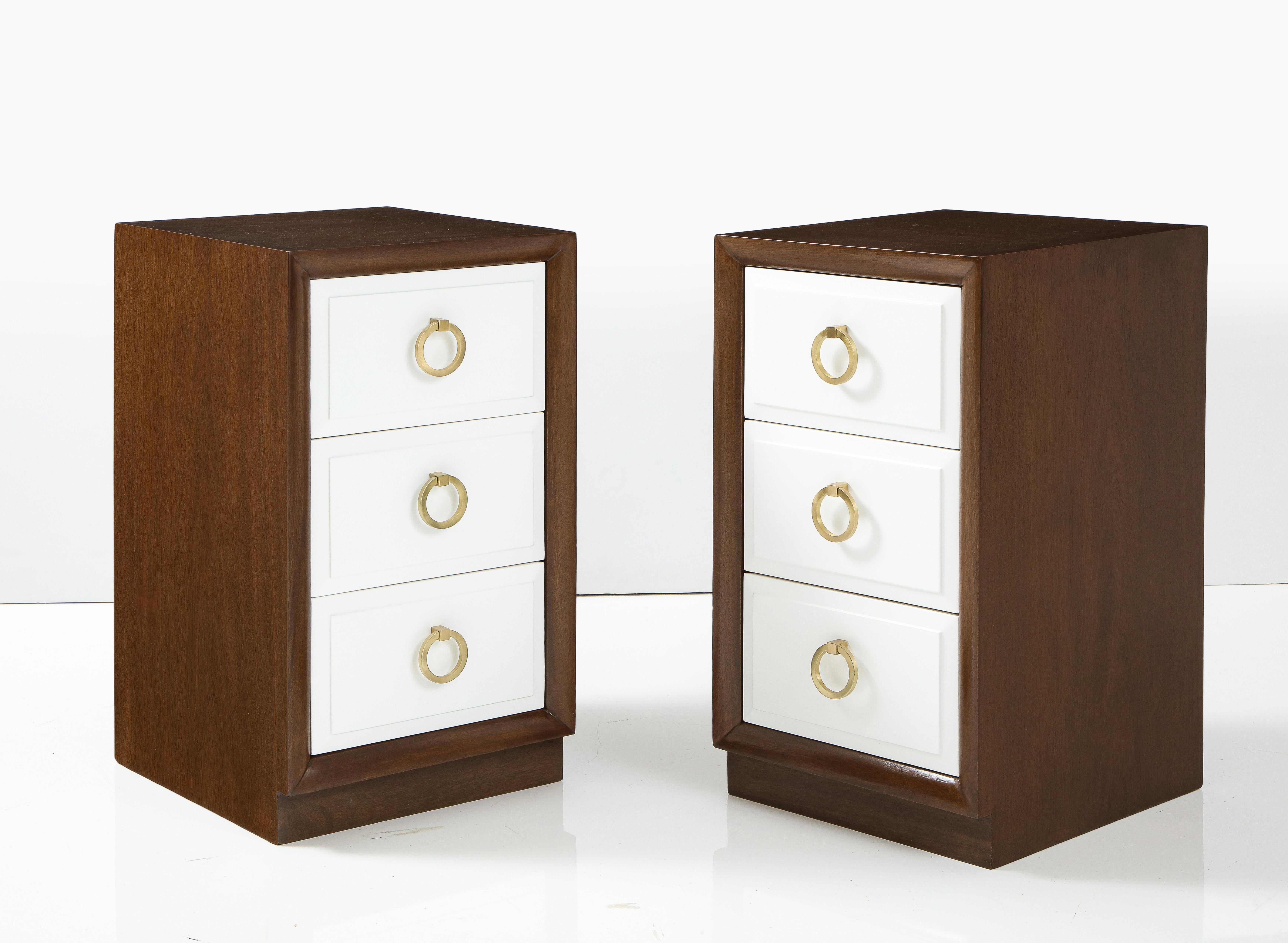 Pair of custom finished Mid Century classically styled nightstands featuring a Walnut case and 3 drawers in a matte off white lacquer and brushed brass pulls. Signed. Mint Restored.