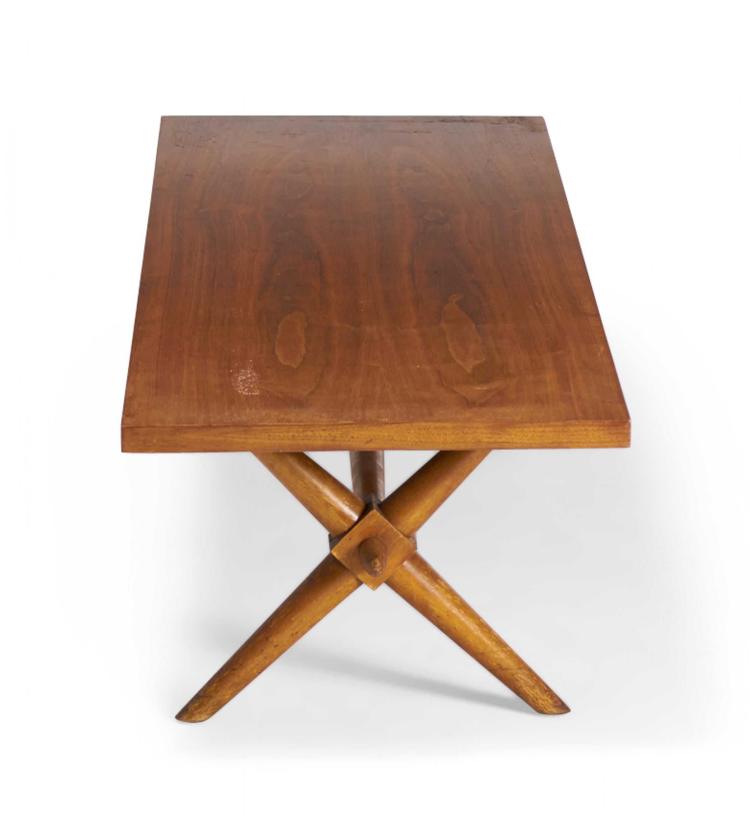 American Mid-Century walnut coffee / cocktail table with a rectangular top resting on a crossed trestle base. (T.H. ROBSJOHN-GIBBINGS)
