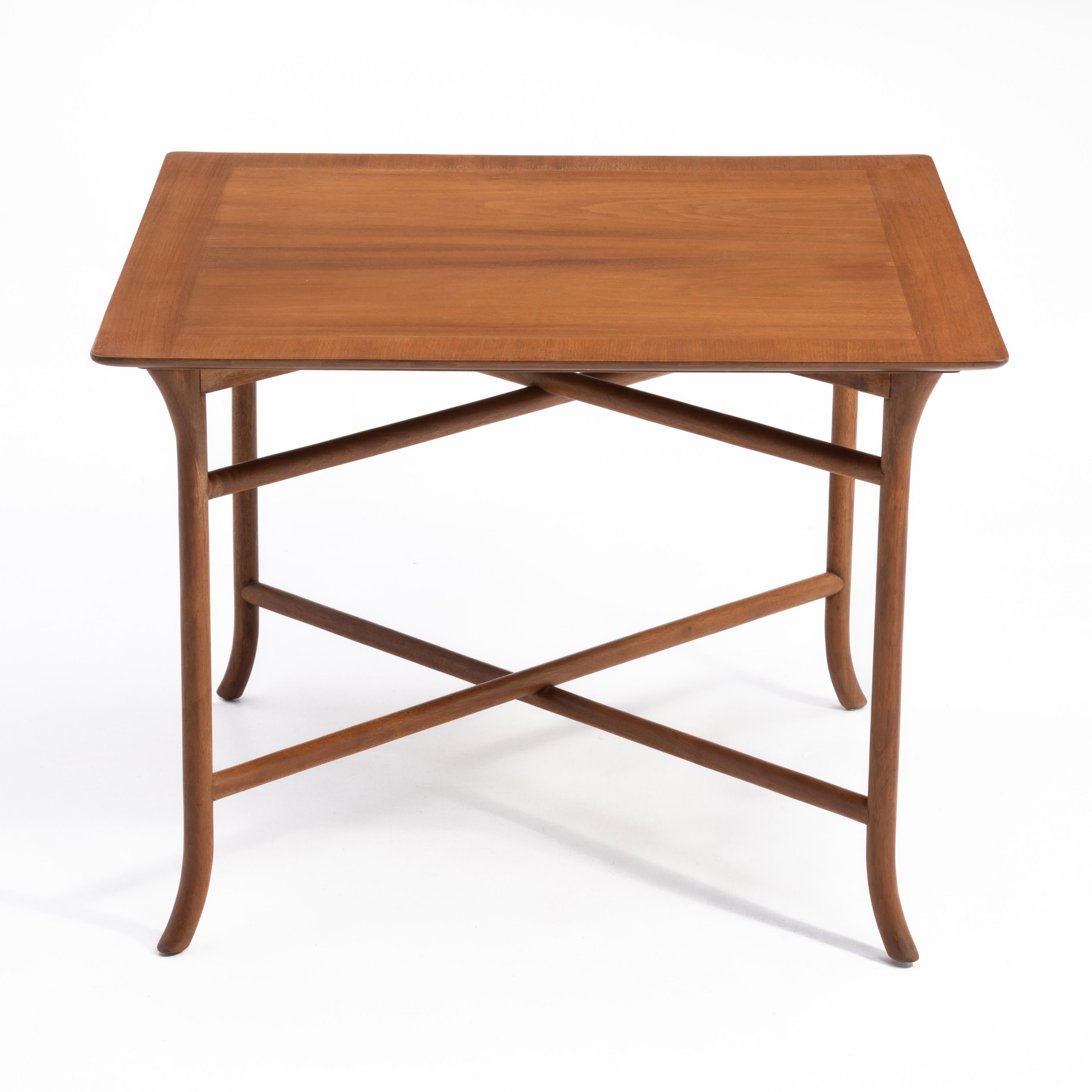 A refined T.H. Robsjohn-Gibbings for Widdicomb table that will serve nicely as a coffee, end or side table. The table is made of bleached mahogany and features carved and curved saber legs and a beveled top with expertly book matched veneer. It has