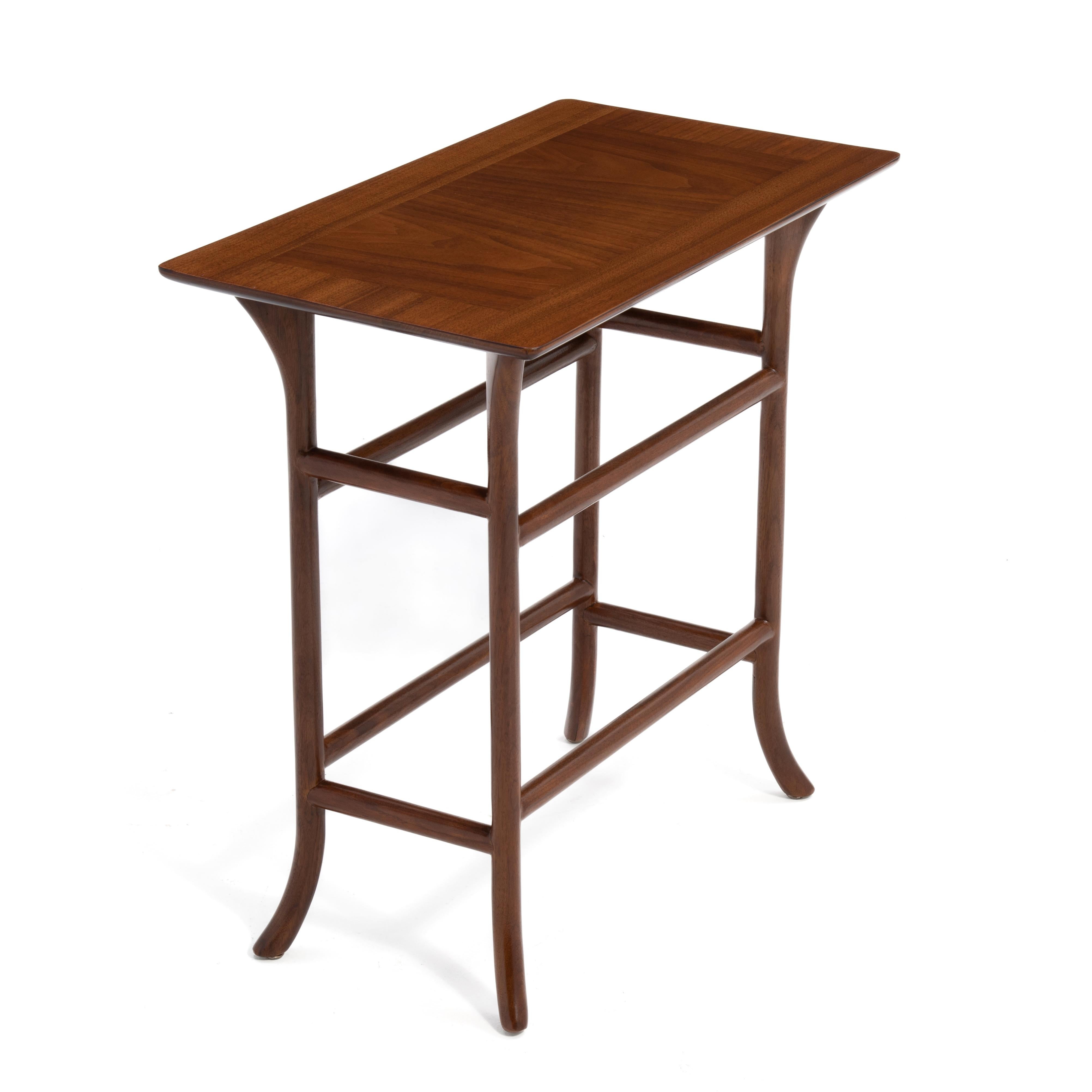 An elegant and versatile drink, lamp or side table by T.H. Robsjohn Gibbings for Widdicomb. Banded and book matched top with the designers signature Klismos legs. The table is unmarked and was made in the 1950s.