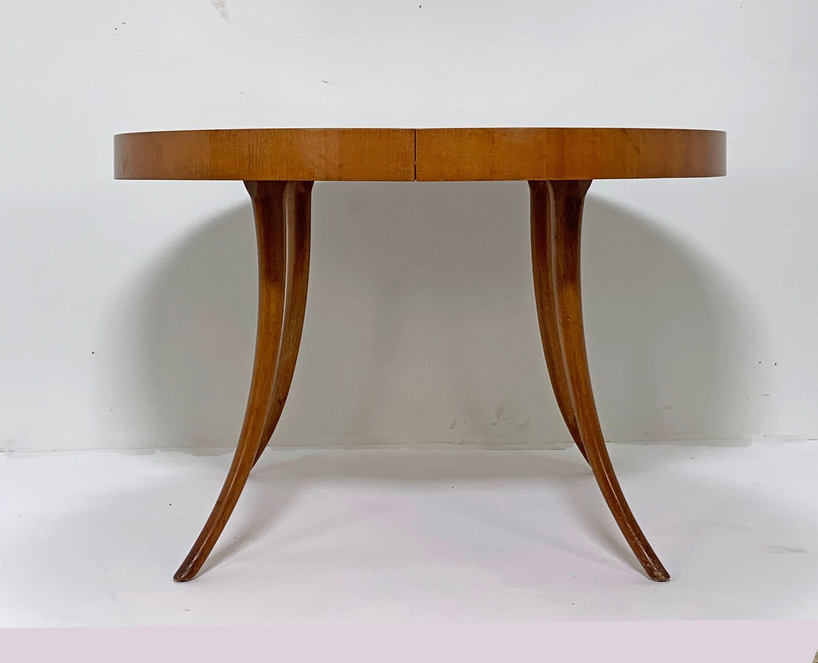 44” round dining table with graceful sabre Klismos legs by T.H. Robsjohn-Gibbings for Widdicomb, circa 1956. Includes all three original 12