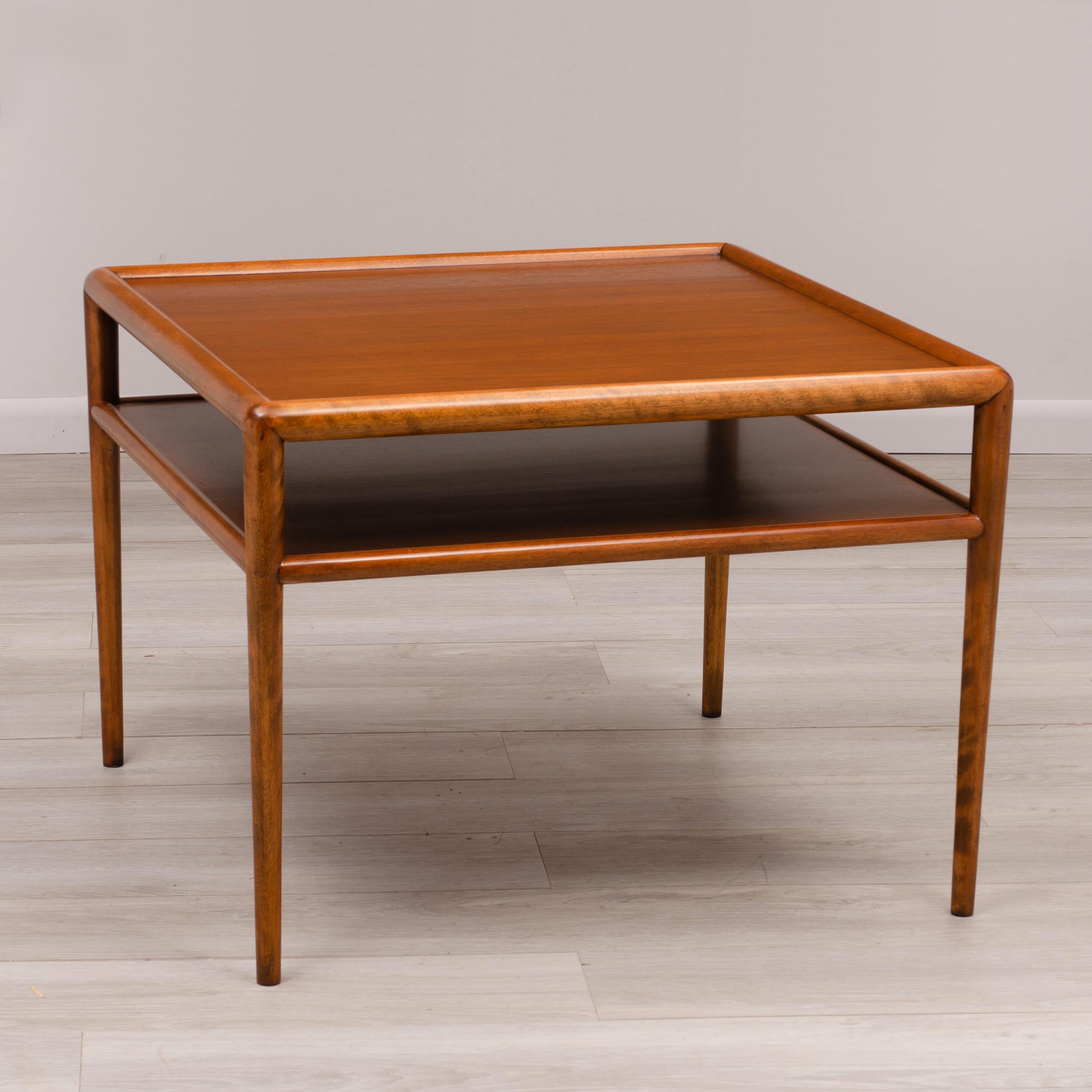 A Mid-Century Modern mahogany two tiered table designed by T. H. Robsjohn-Gibbings for Widdicomb. Made in July of 1953.