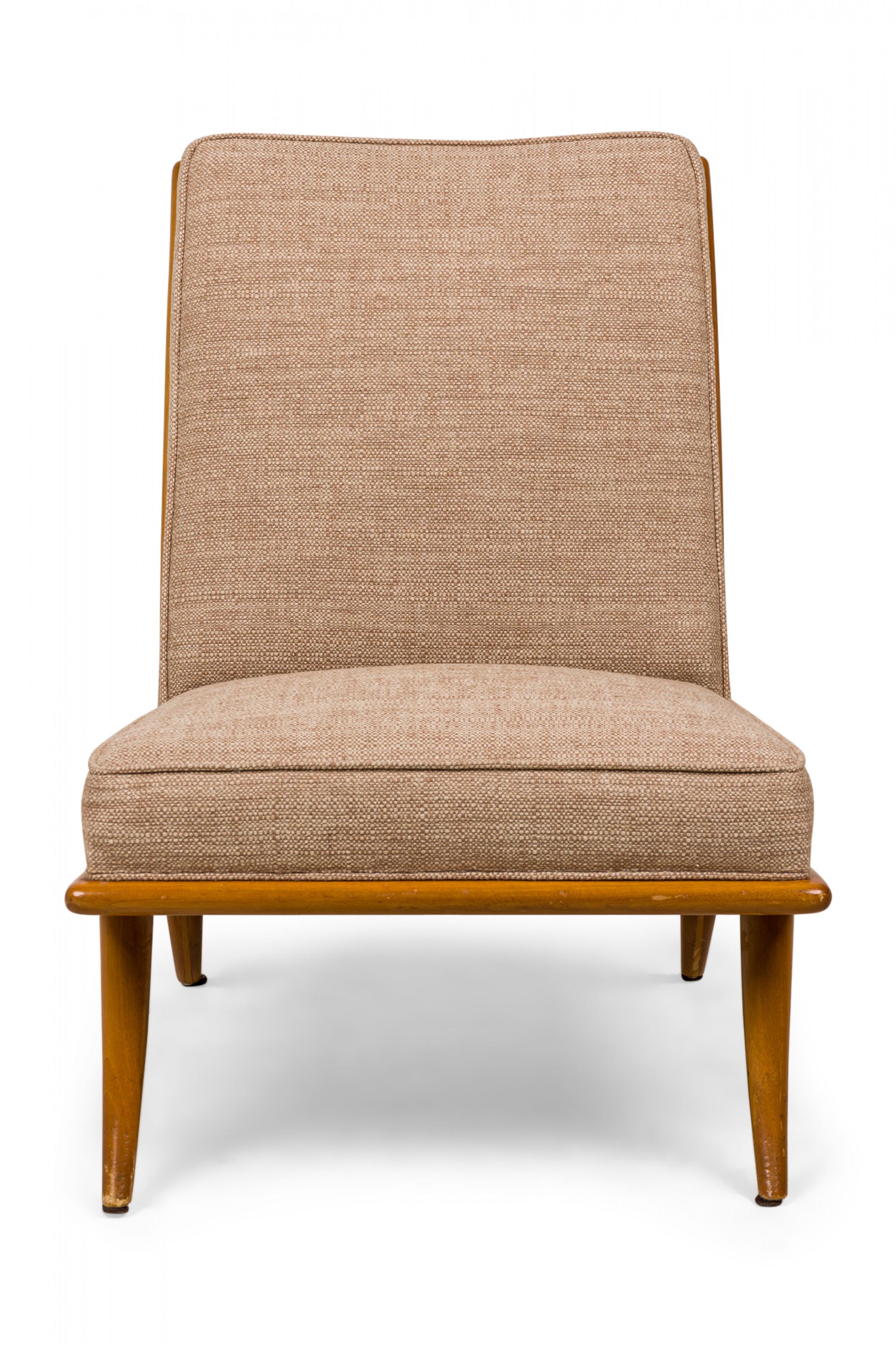 Mid-Century slipper / side chair with textured tan fabric upholstery and a walnut frame resting on four gently curved and tapered legs. (T.H. ROBSJOHN-GIBBINGS FOR WIDDICOMB)(Similar pieces: DUF0544, DUF0546)

