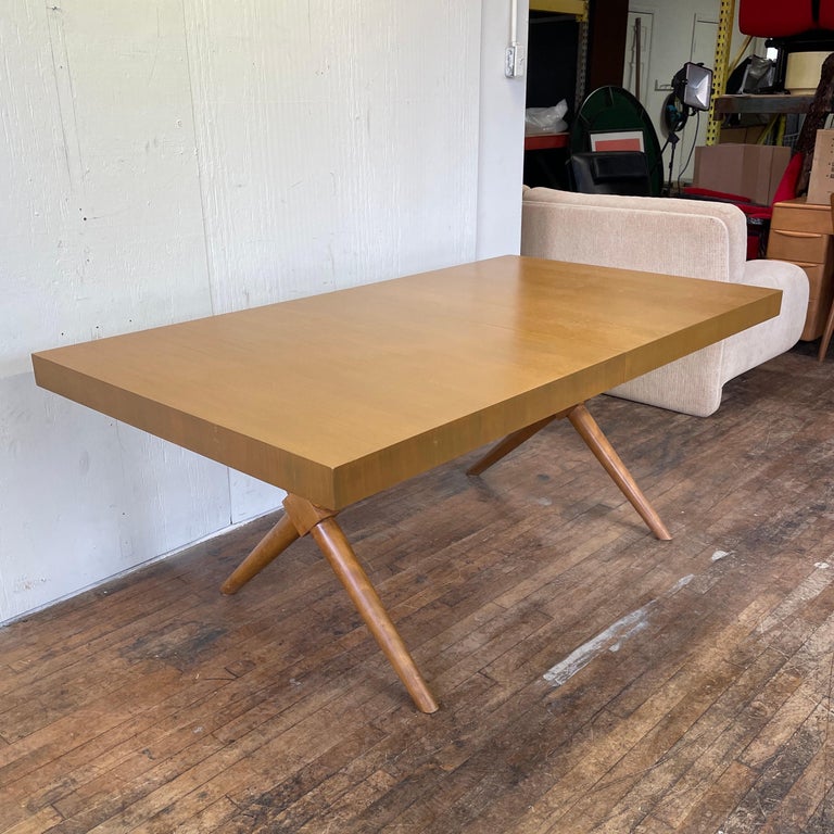 A vintage Widdicomb dining table designed by T.H. Robsjohn-Gibbings. The table is in great shape with firm joints, clean finish, and only a few light scratches. It is marked on the bottom with the original paper label. No leaves are included.