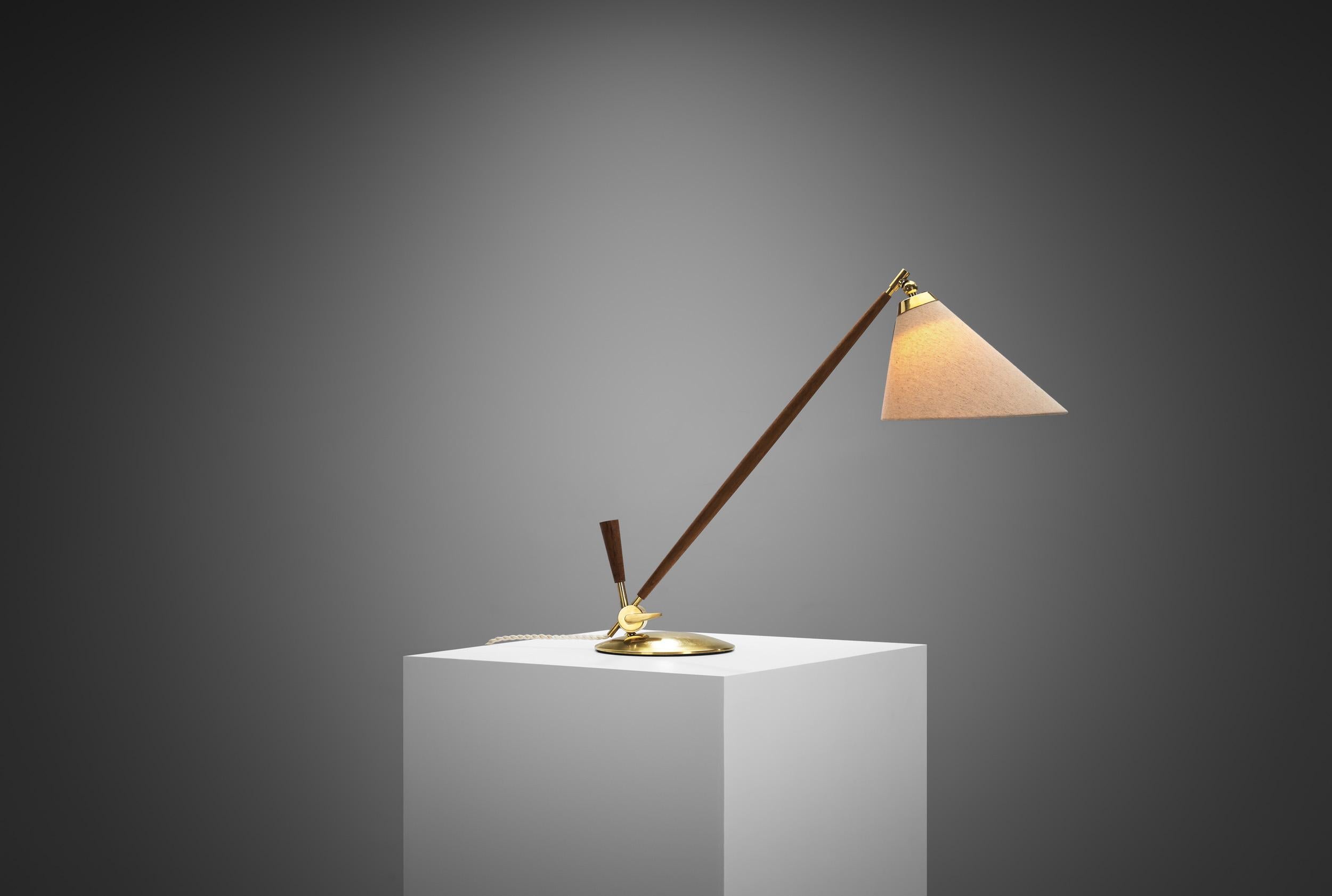 The ‘THV 375’ table lamp was designed by Thomas Valentiner and produced for Poul Dinesen in Denmark. Crafted from brass and teak, this fully adjustable table lamp is perfectly balanced and has an understated design. The Danish designer Th.