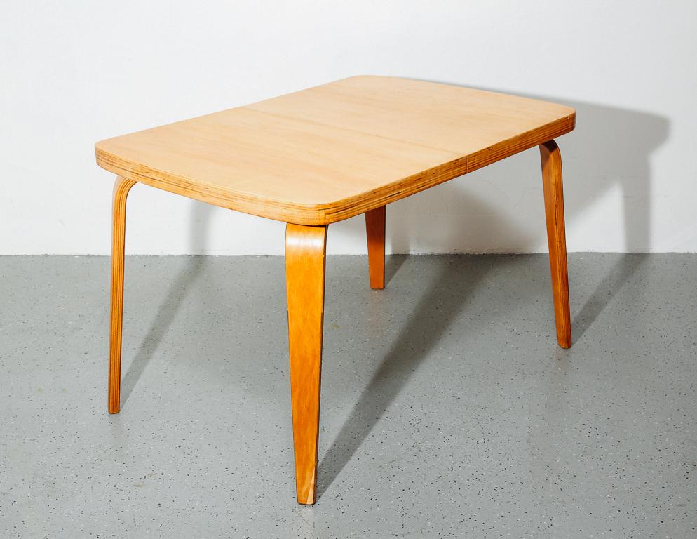 Bentwood dining table manufactured by Thaden Jordan, 1940s. Contemporary of the bent plywood Eames designs of the time, this piece by Thaden Jordan epitomizes post-war technology and design. Includes one extension leaf.
