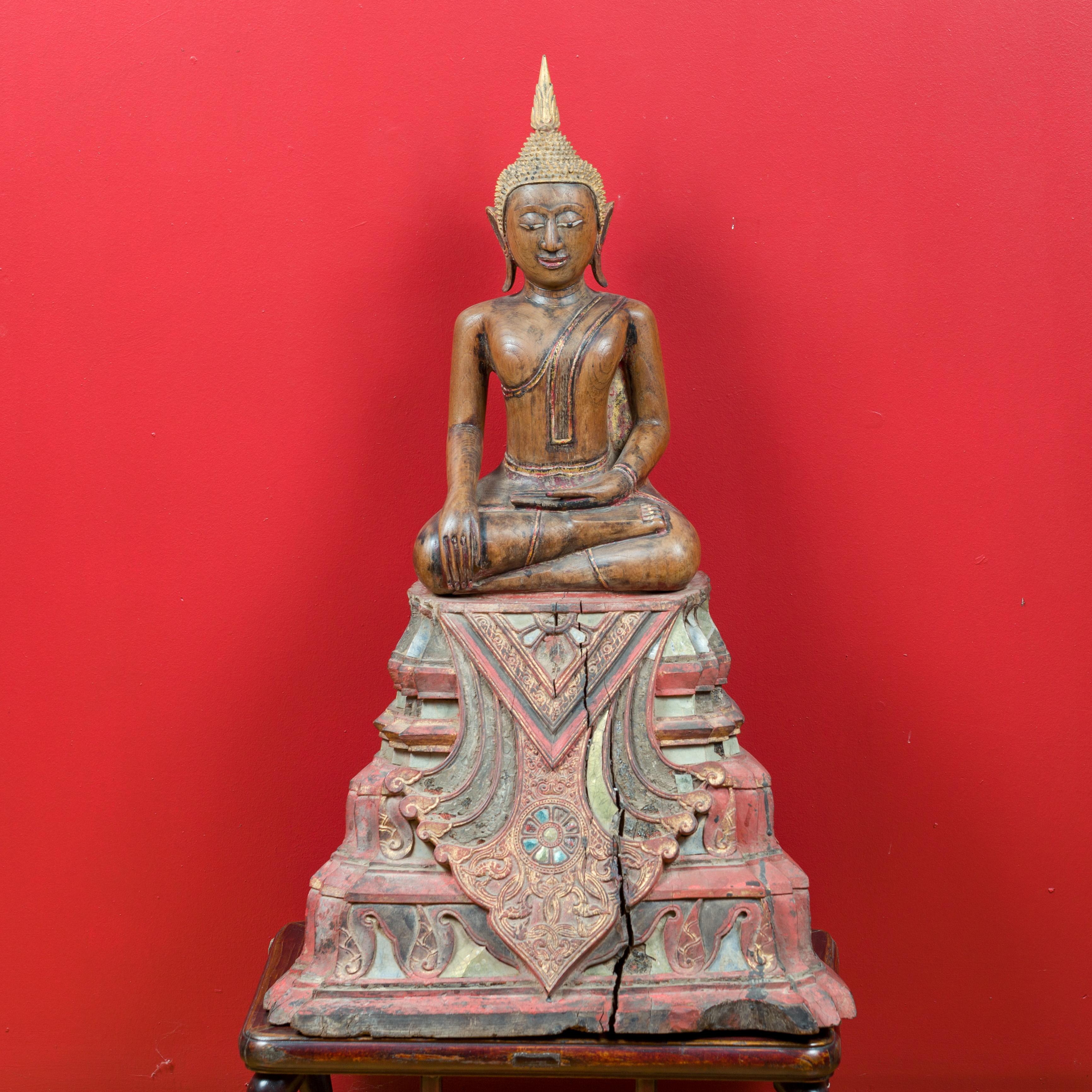 A Thai teak wood seated Buddha sculpture from the 17th-18th century, in the Calling the Earth to Witness position. Created in Thailand during the 17th or 18th century, this carved sculpture depicts the Buddha during the meditation that will bring
