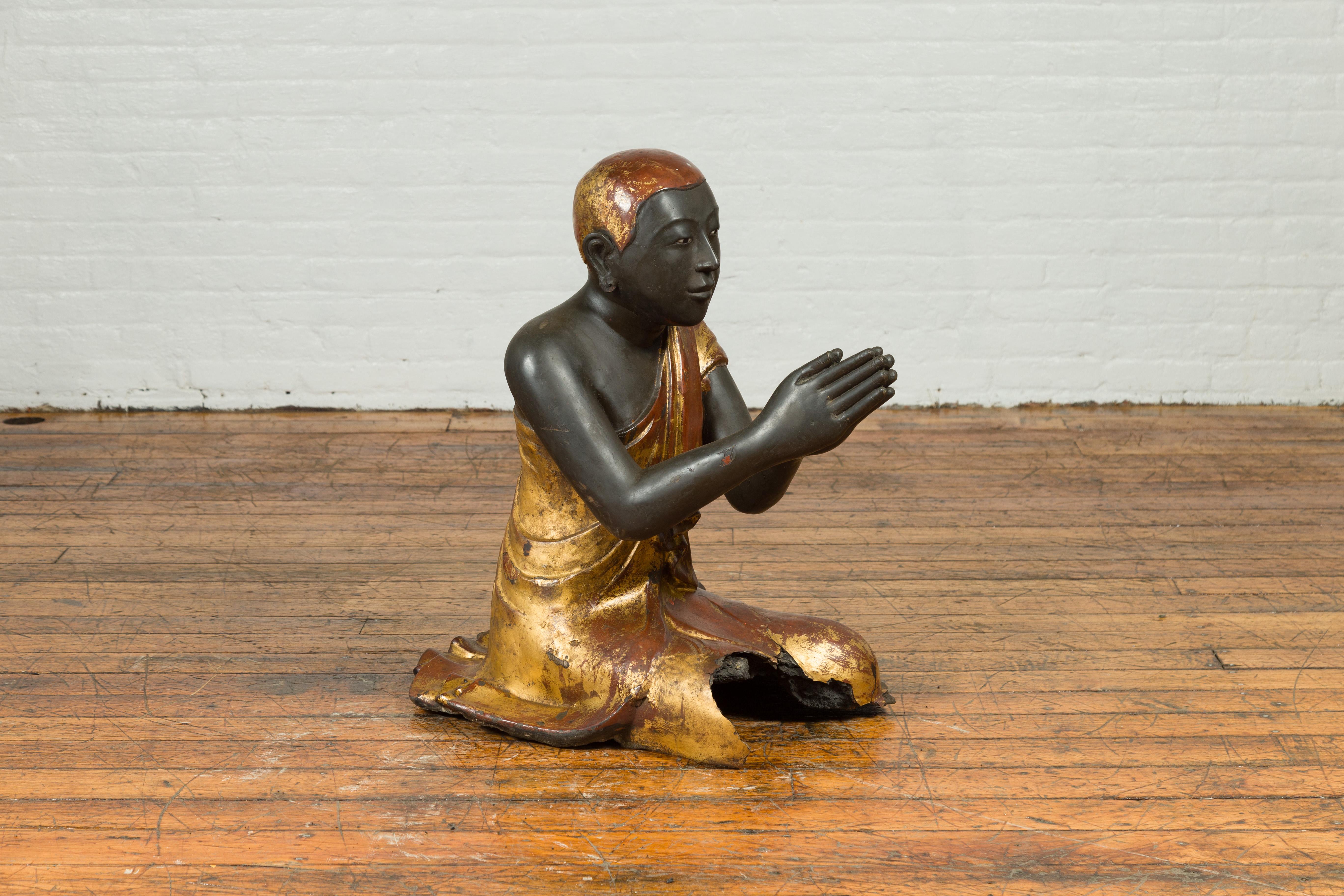 praying monk statue