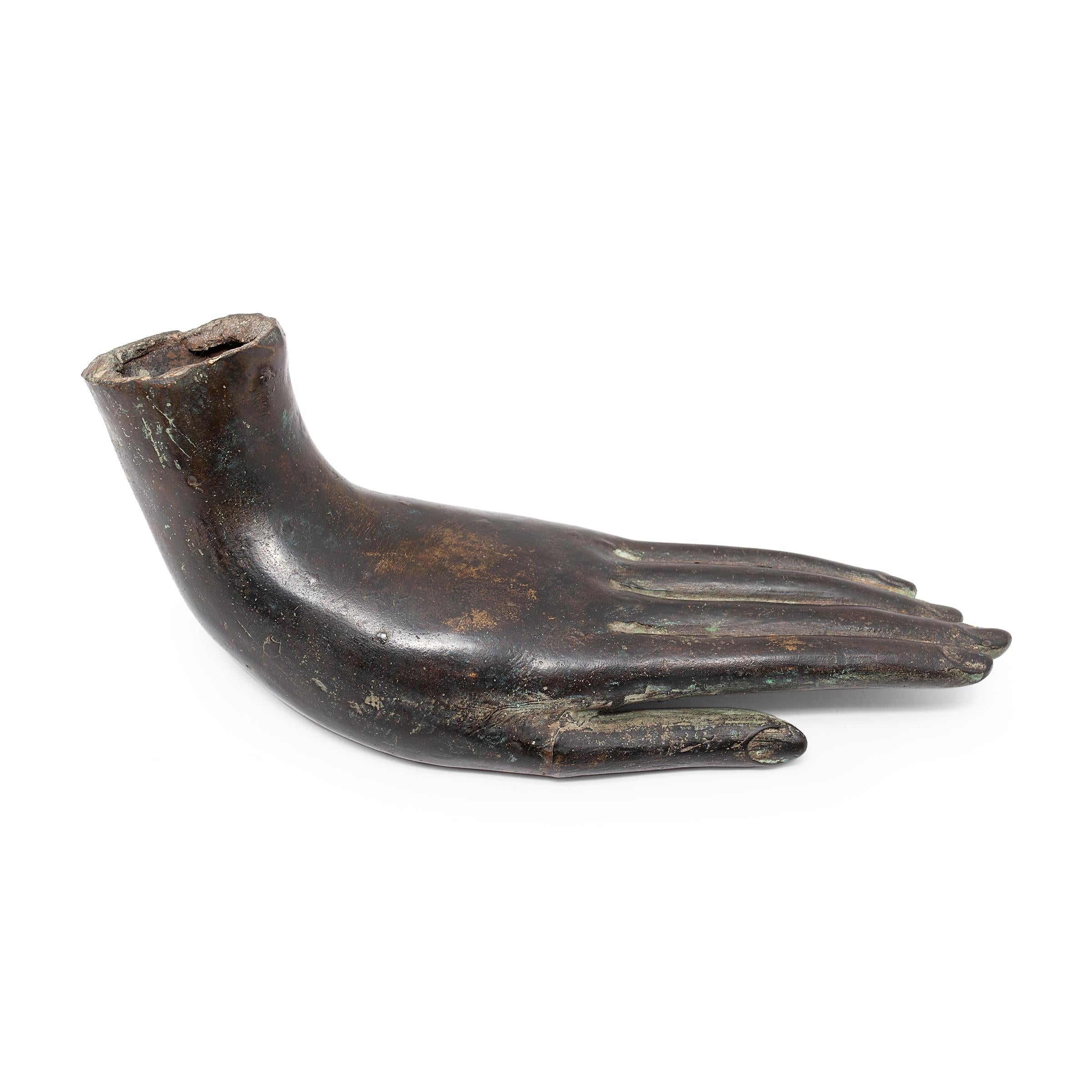 This 19th-century Buddha's hand sculpture from Thailand is finely cast of bronze with lifelike features and a beautifully dark patina. The slender left hand is held gracefully in varada mudra, the gesture of mercy and compassion, with wrist bent and