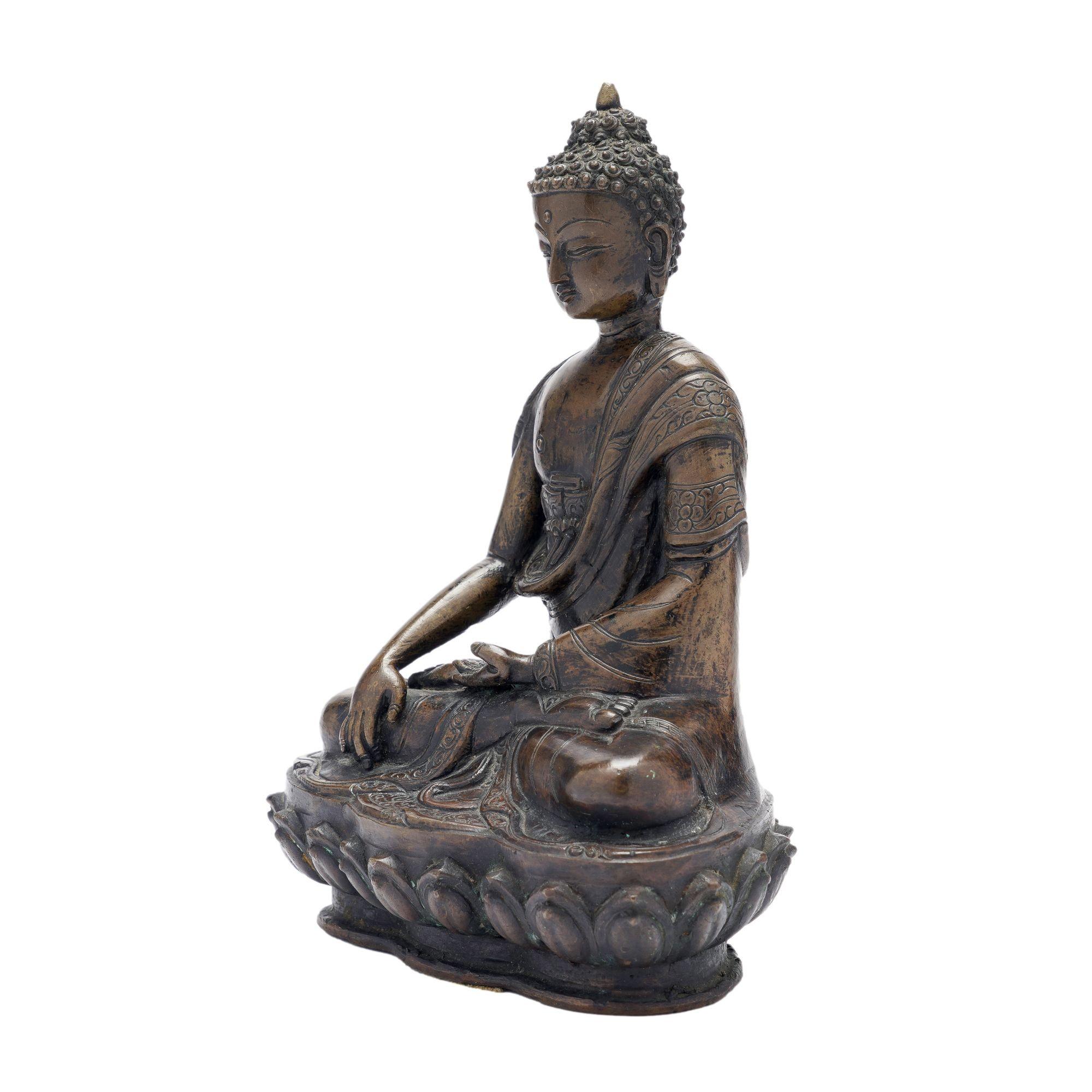 Cast bronze Buddha seated in a meditation mudra on a lotus throne. The bronze a rich patina accenting the delicate sculptural details in the casting.
Thailand, fourth quarter 1800's.