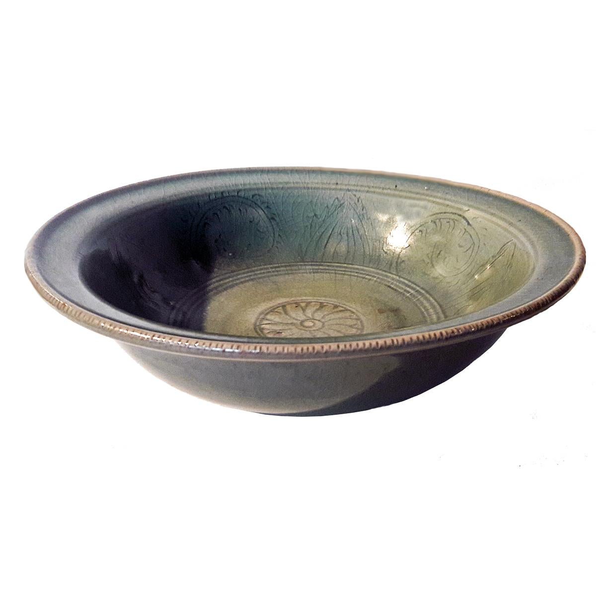 A Thai Celadon plate, with traditional jade-color, crackled glaze, circa 1890. Lotus decoration in the center and inside.