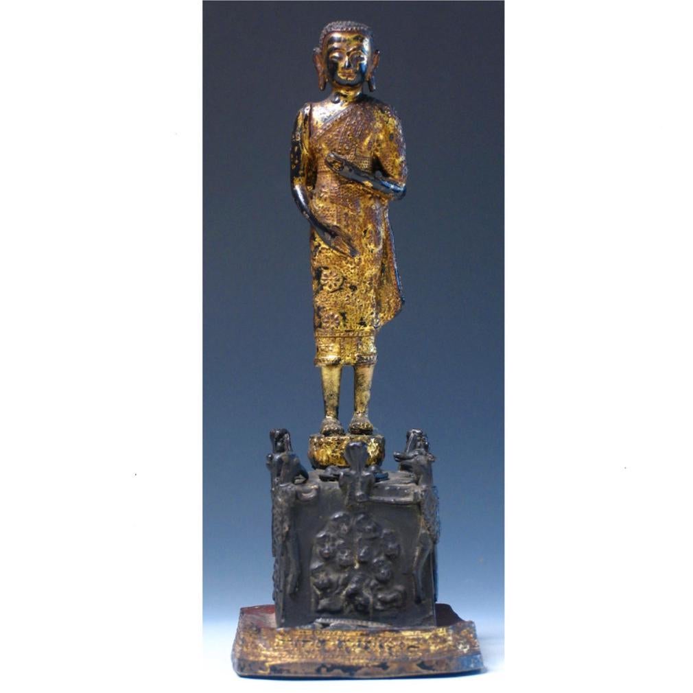 Thai gilded copper alloy sculpture of Phra Malai visiting the damned to hell, a standing monk image with a basket slung over his right shoulder costumed in relief floral decorated robe standing on a lotus base affixed to a square base having a