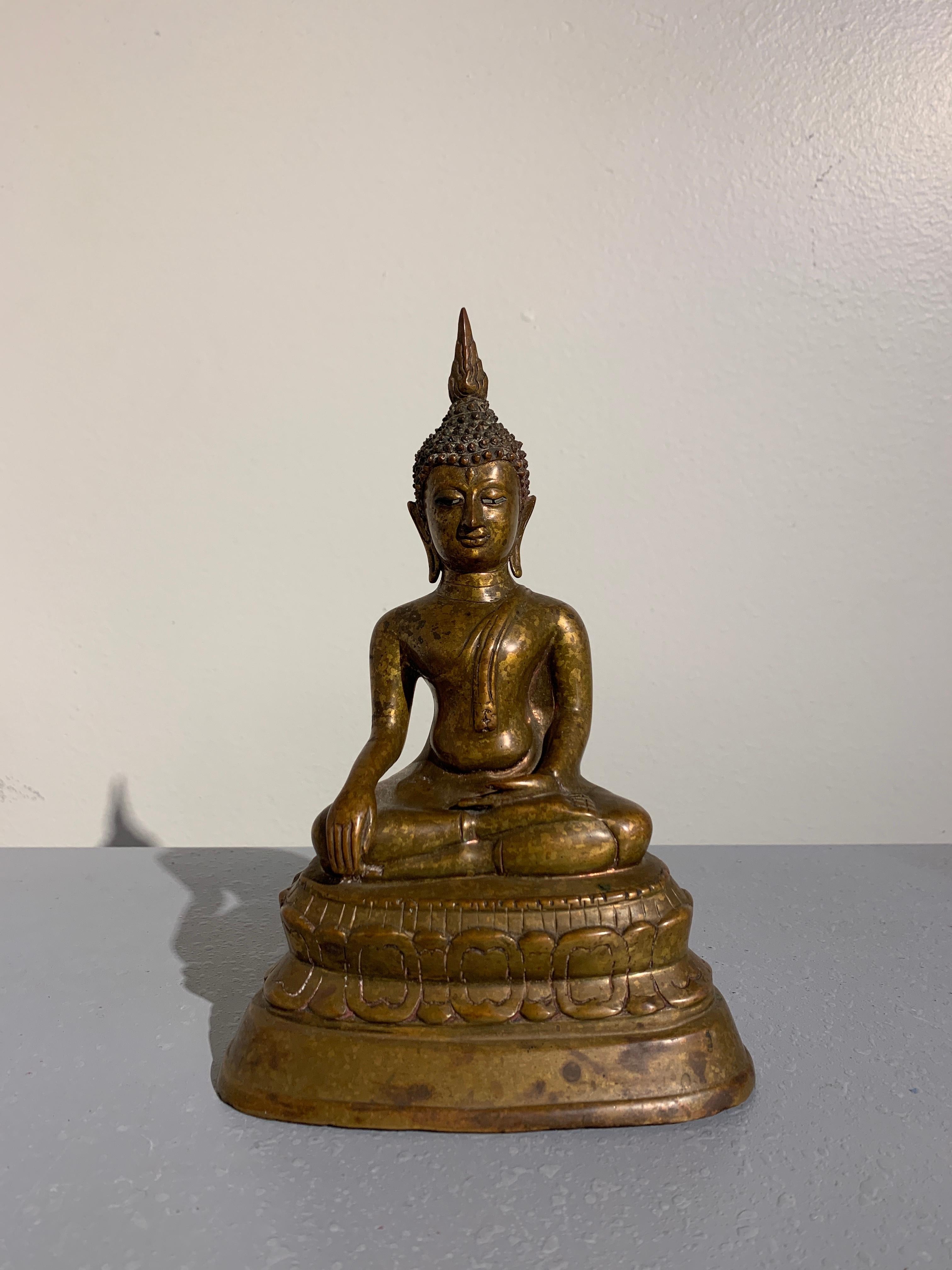 A rare and beautiful Thai cast and gilt bronze seated Buddha with shell inlaid eyes, style of Wat Chedi Luang, Lan Na Kingdom, Northern Thailand, region of Chiang Mai, late 15th century. 

The historical Buddha, Shakyamuni, is portrayed seated in