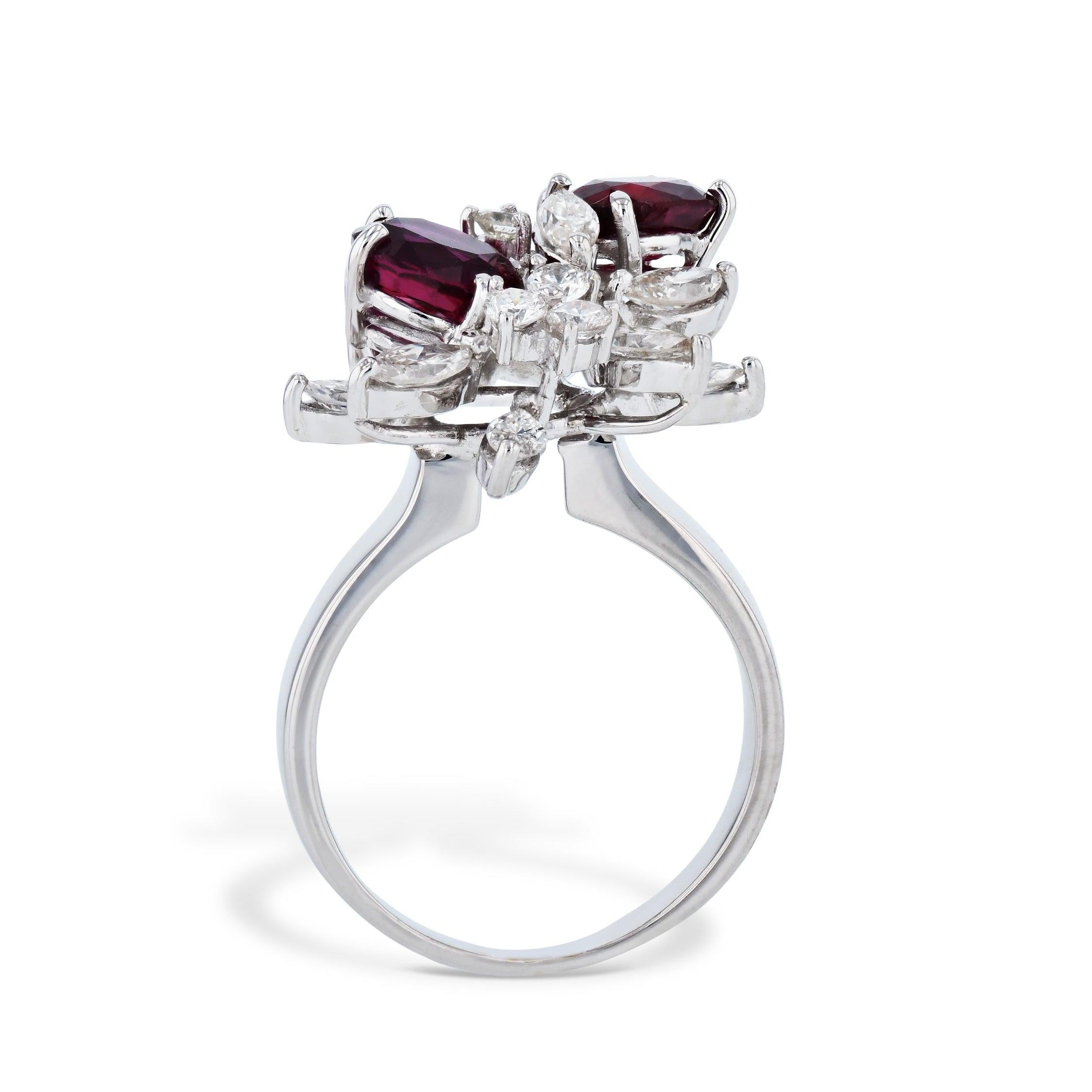 This exquisite 18kt White Gold Thai Oval Rubies and Diamond Estate Ring is sure to take your breath away! Featuring 3.45ct TW Oval Rubies and Round and Marquise Diamonds - this stunning piece is sure to be treasured for years to come! Add this