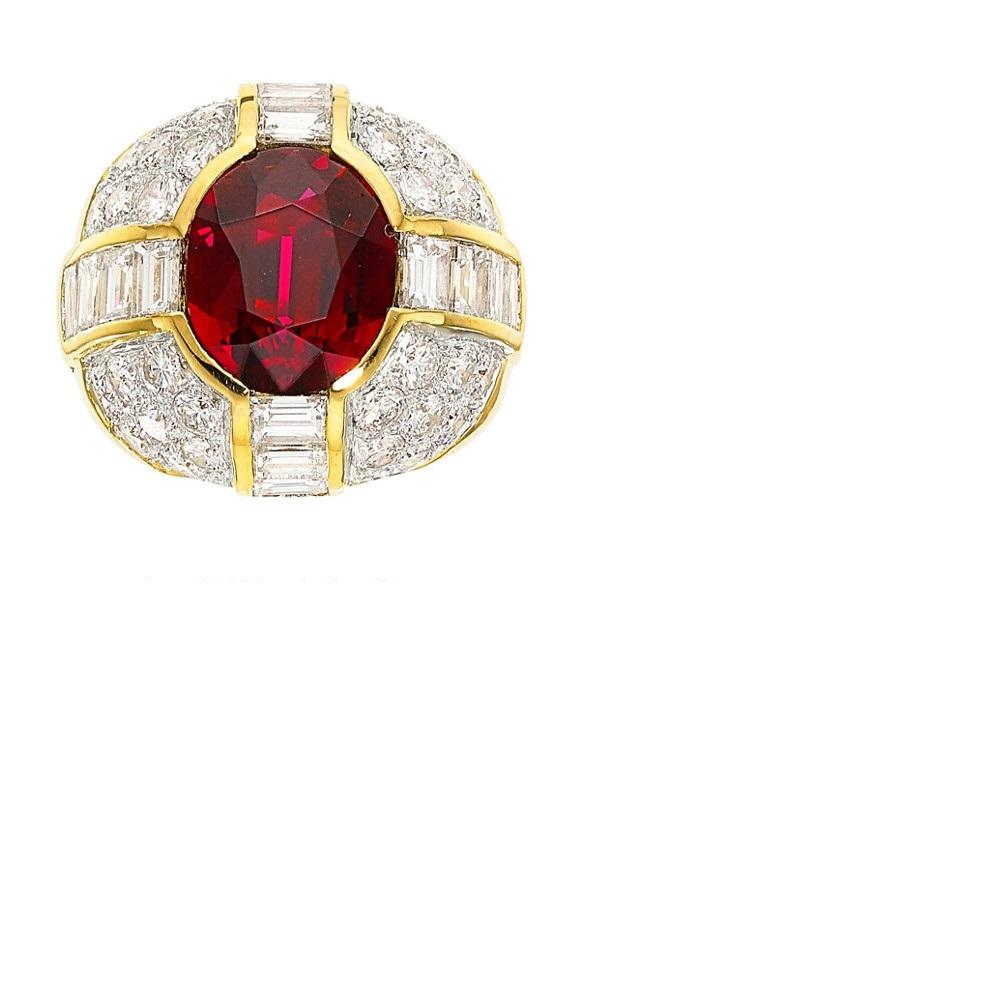 A large and impressive ruby weighing 4.50 carats takes center stage of this dome styled gold and diamond ring. The ruby has an intense and vivid red color with excellent clarity as the stone is not only eye clean but loupe clean (no inclusions can
