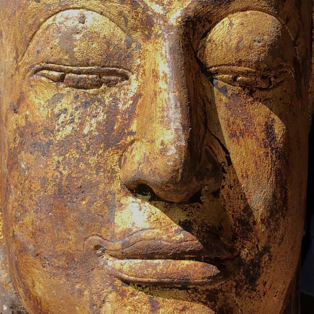 Thai Sandstone Carving of the Head of A Buddha Image, Ayutthaya, 15th Century. This sculpture has carved features with full lips outlined with an incised line known as a “trace”, the “U” of the chin broad, long aquiline nose , protruding large and