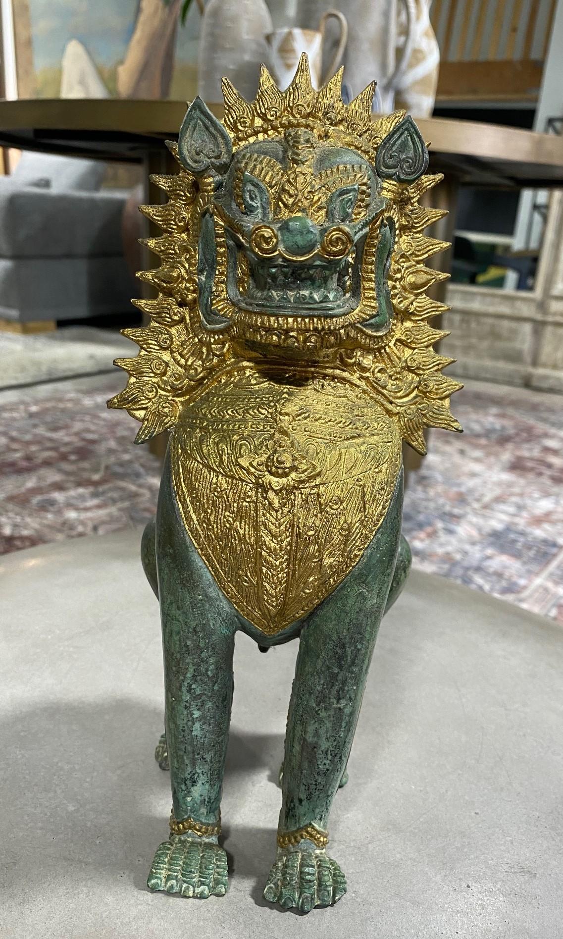 A beautiful Thai or Khmer bronze verdigris and golden parcel-gilt Imperial guardian temple Singha lion/dragon/foo dog. This piece has a wonderful patina and heft to it. 

Likely mid to late 20th century but perhaps older. 

Would be a great