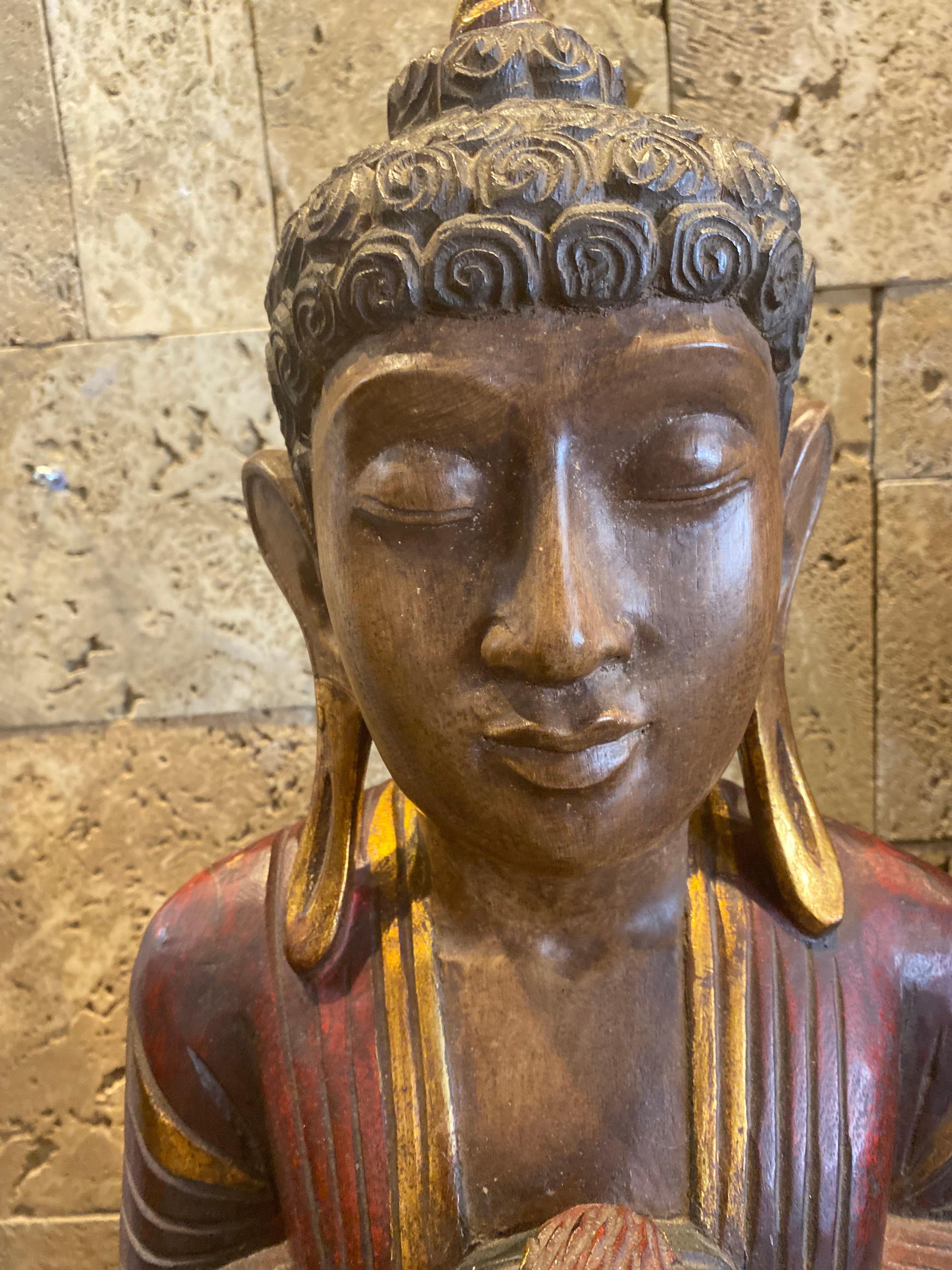 This Thai standing Gautama Buddha is hand painted on hardwood. He Represents wisdom and compassion 