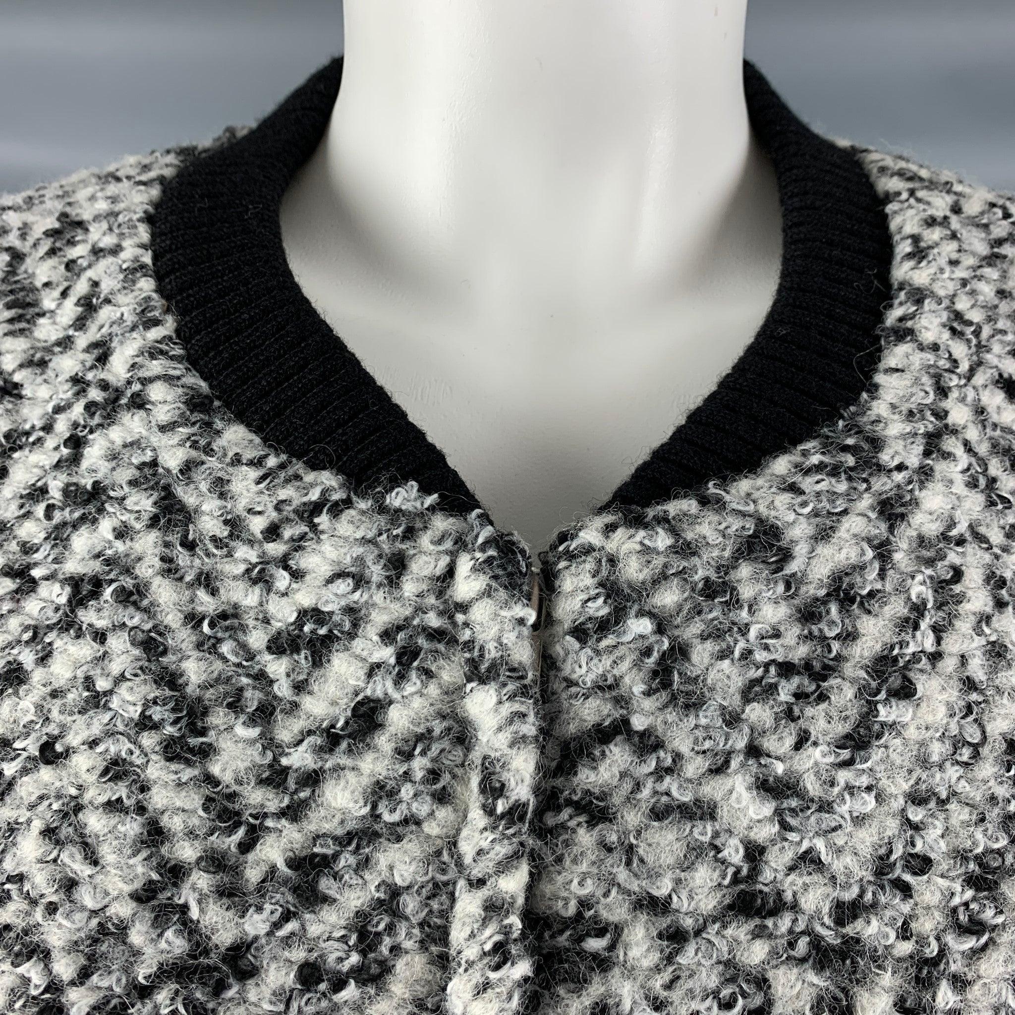 THAKOON jacket comes in a black, grey and white acrylic blend boucle and a black lambskin leather featuring a collarless style, black ribbed accents, and a zip up closure. Excellent Pre- Owned Condition. 

Marked:   0 

Measurements: 
 
Shoulder: 16