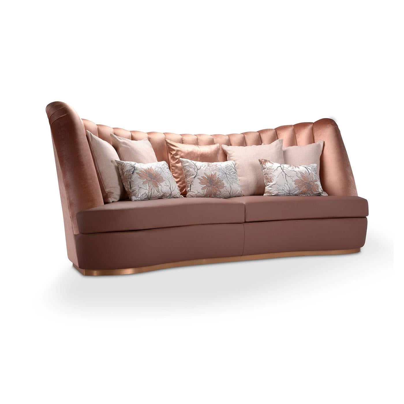 Thalia, one of the nine Greek muses and patron of comedy, inspired the whimsical design of this artisan, three-seater sofa, marked by sinuous curves and a stunning fluted texture enlivening the imposing backrest covered in brown velvet. The wooden